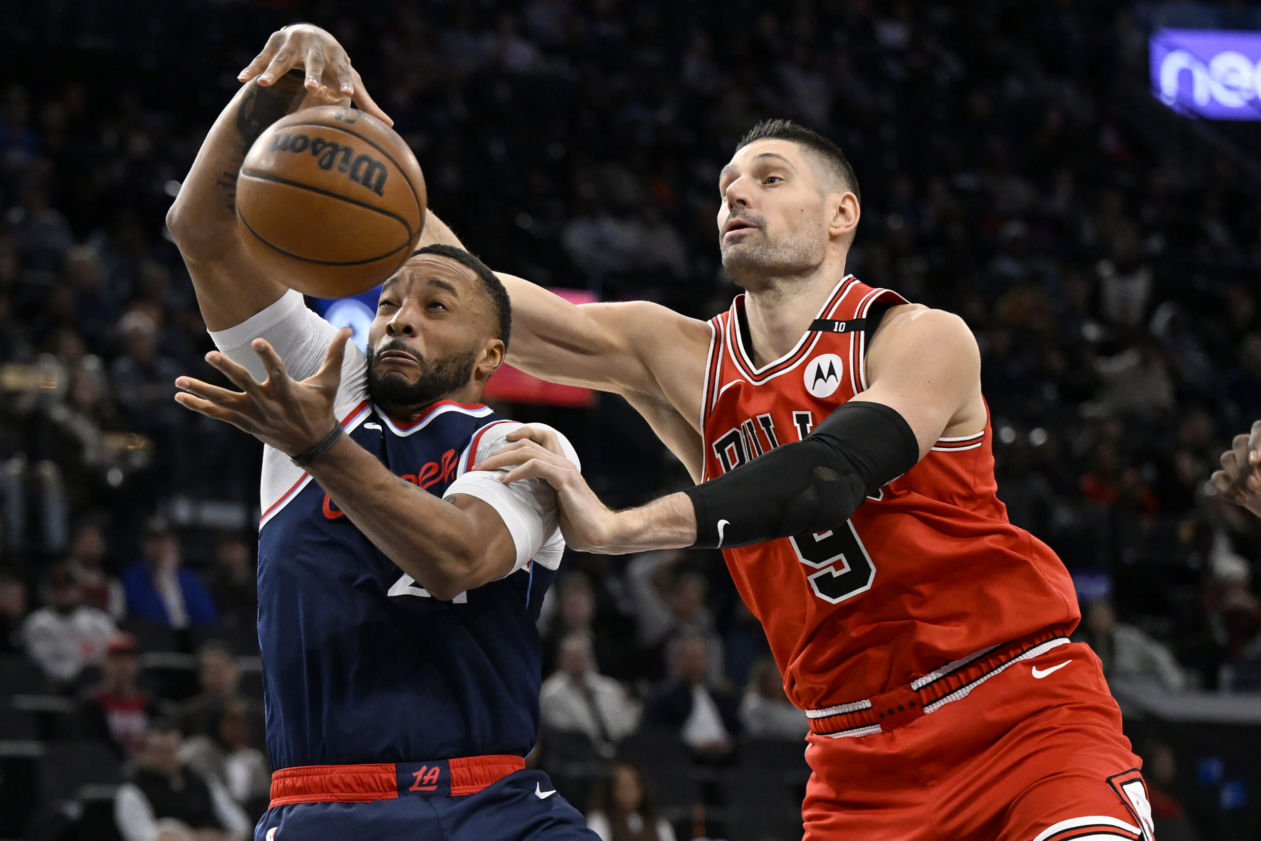 Clippers guard Norman Powell, left, vies for the ball with...