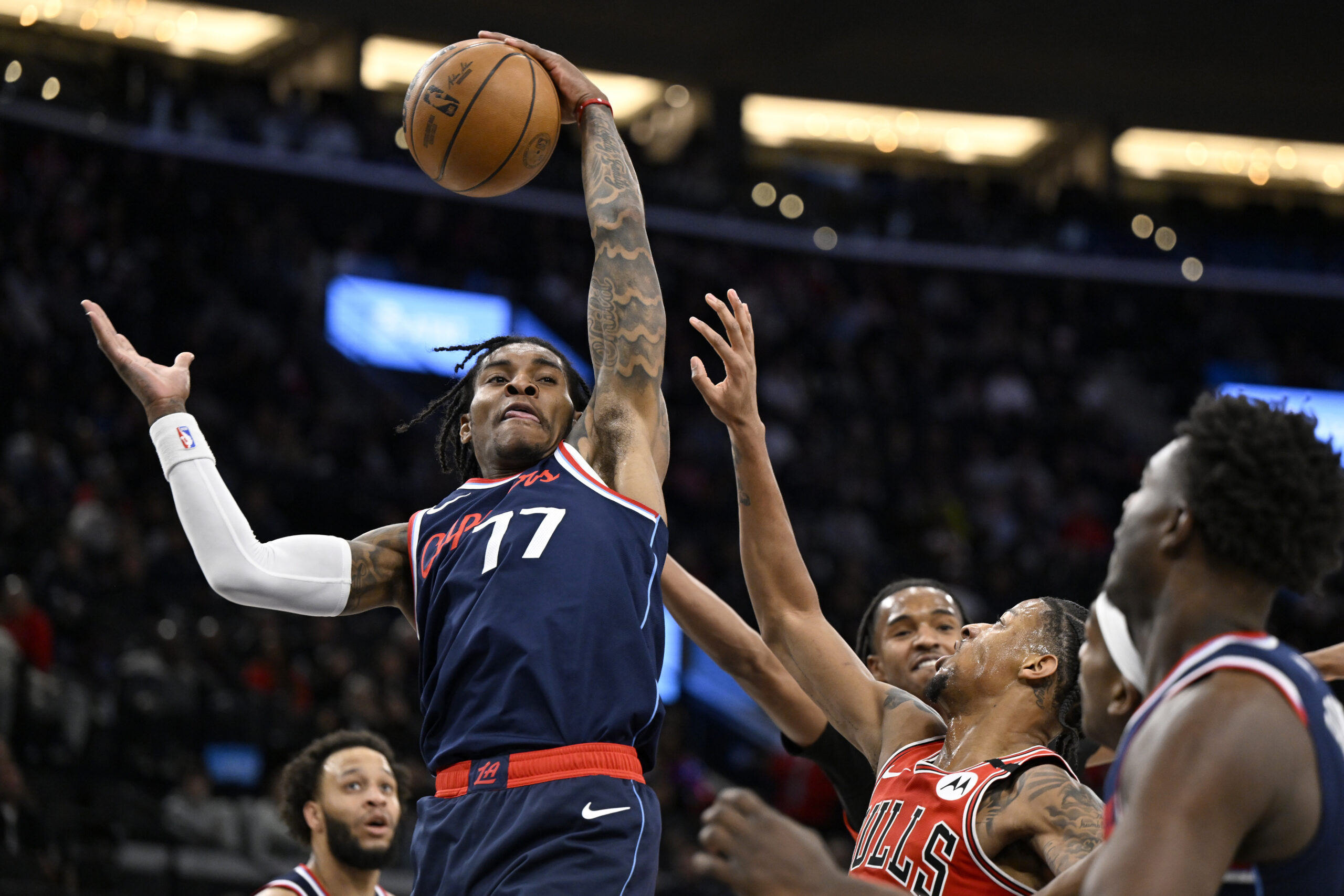 Clippers guard Kevin Porter Jr. (77) pulls down a rebound...