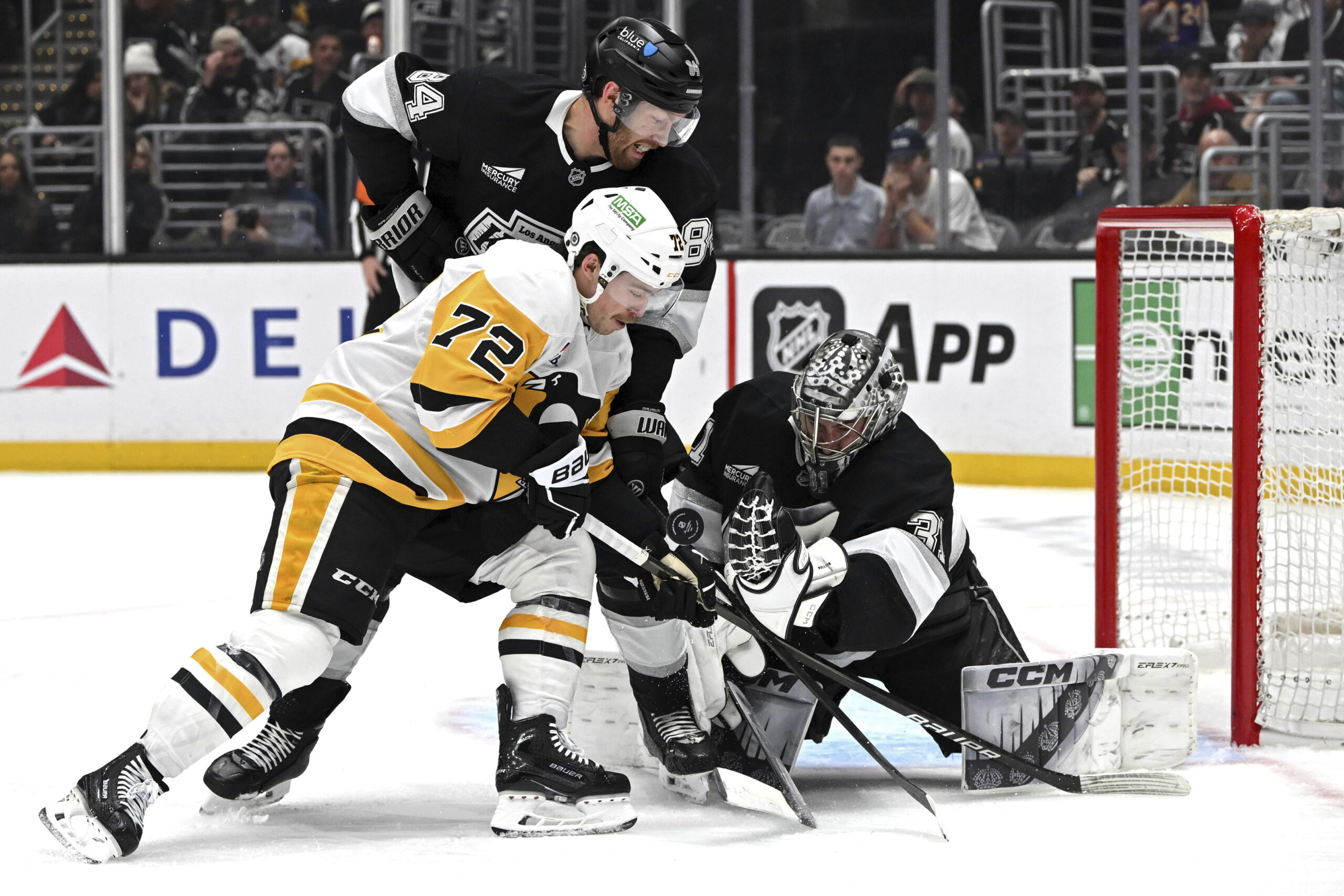 Kings goaltender David Rittich, right, blocks a shot by Pittsburgh...