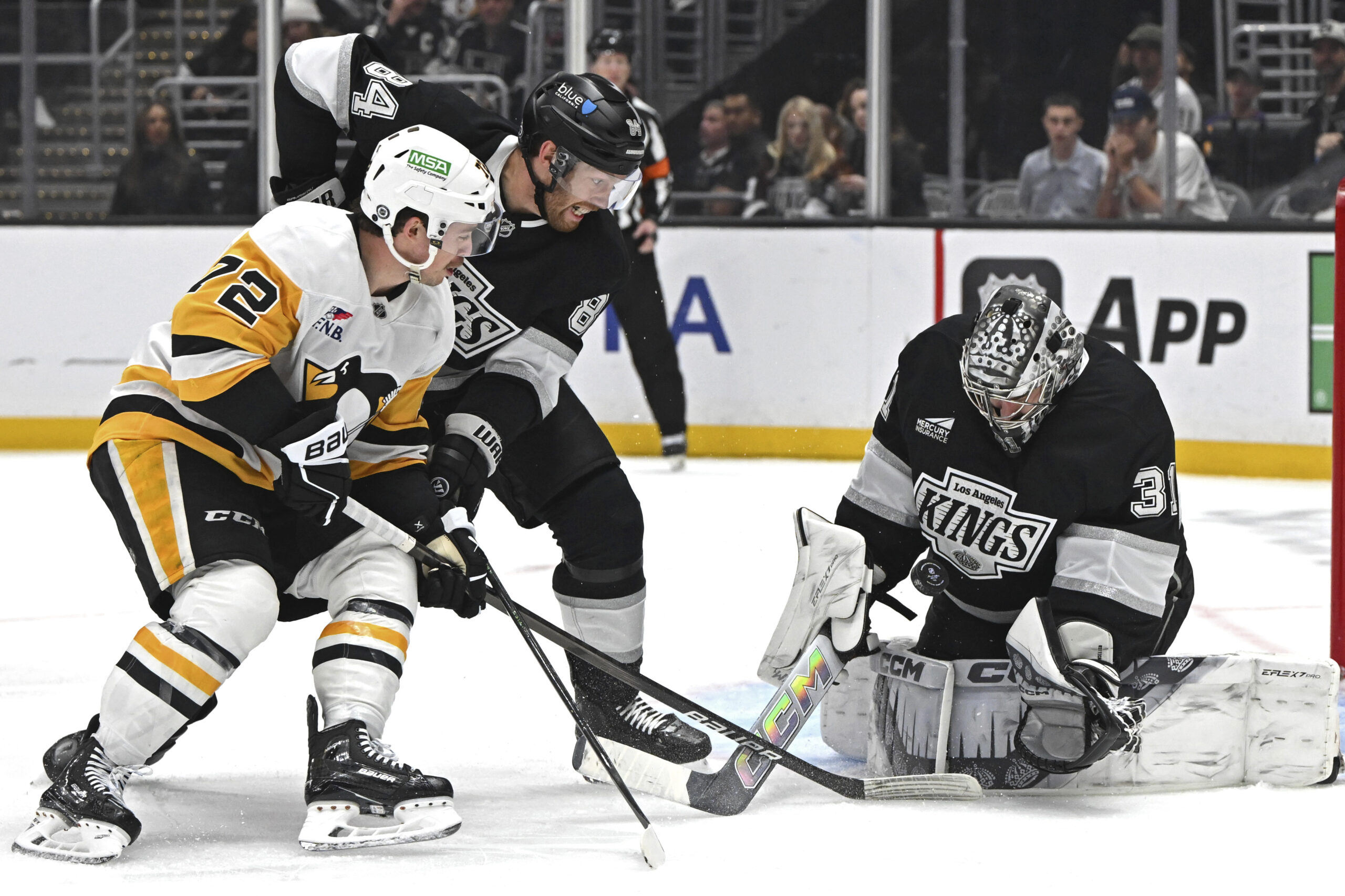 Kings goaltender David Rittich, right, blocks a shot by Pittsburgh...