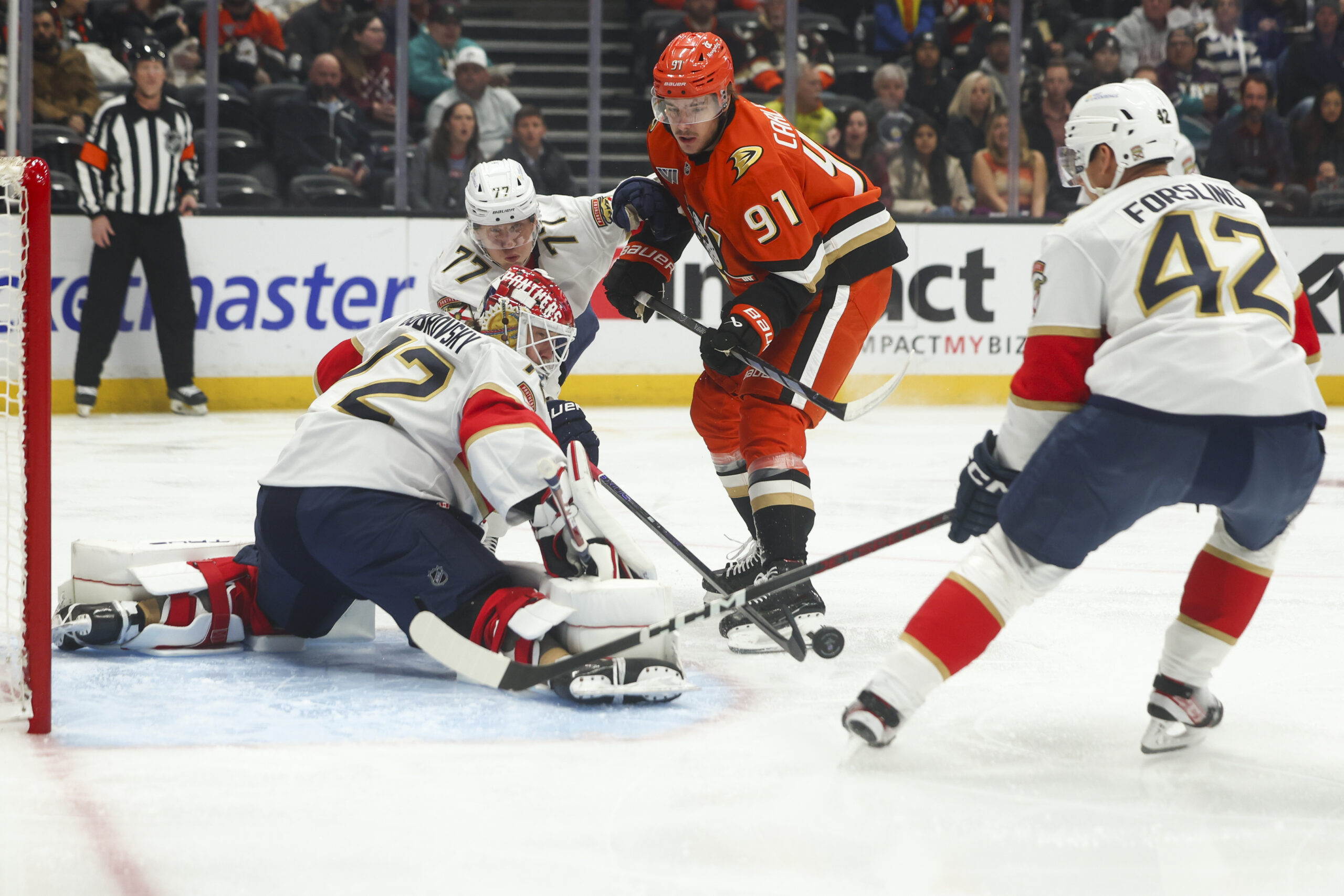 Florida Panthers defenseman Niko Mikkola (77) deflects the puck shot...