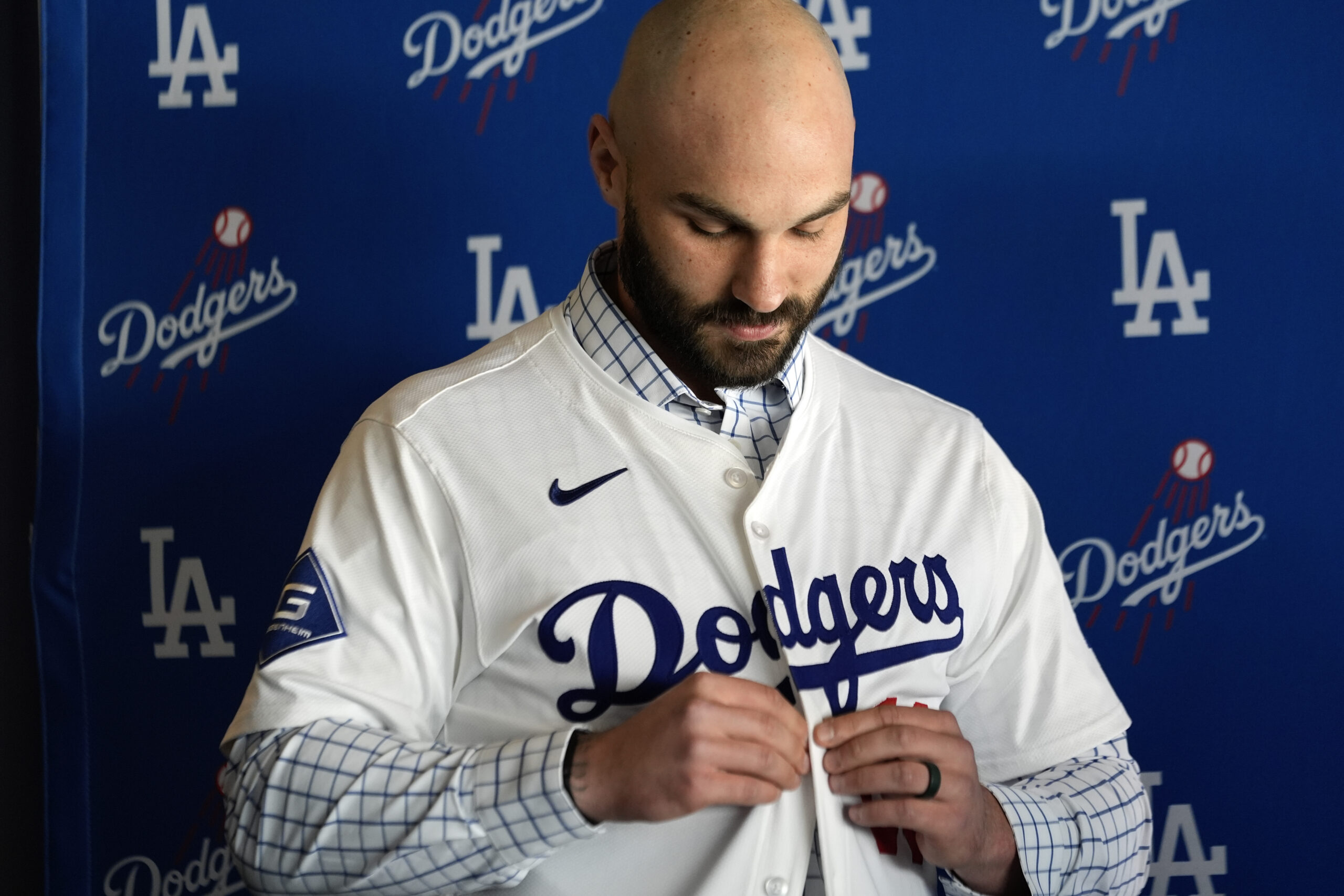 New Dodgers relief pitcher Tanner Scott buttons up his new...