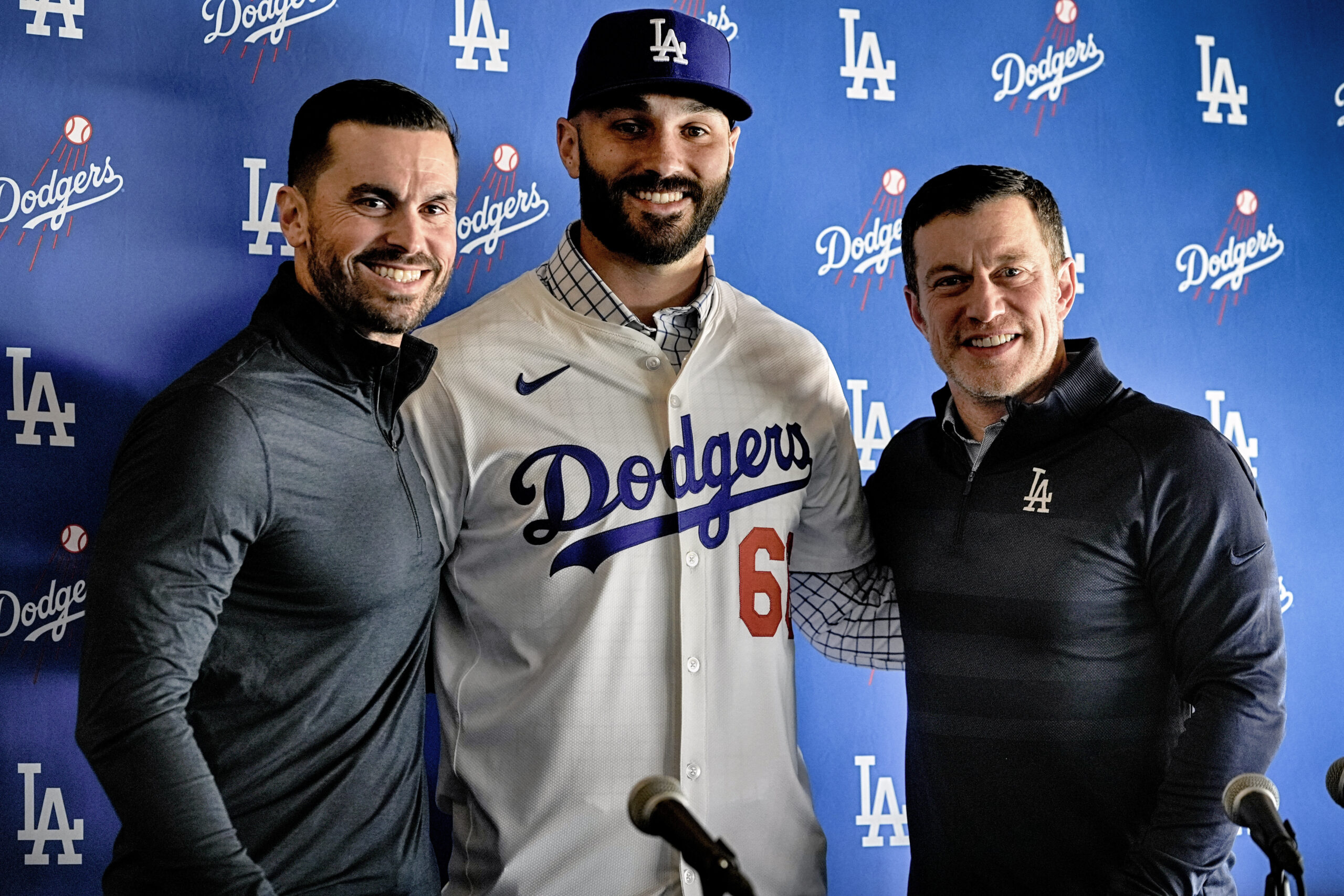 New Dodgers relief pitcher Tanner Scott, center, poses with Dodgers...