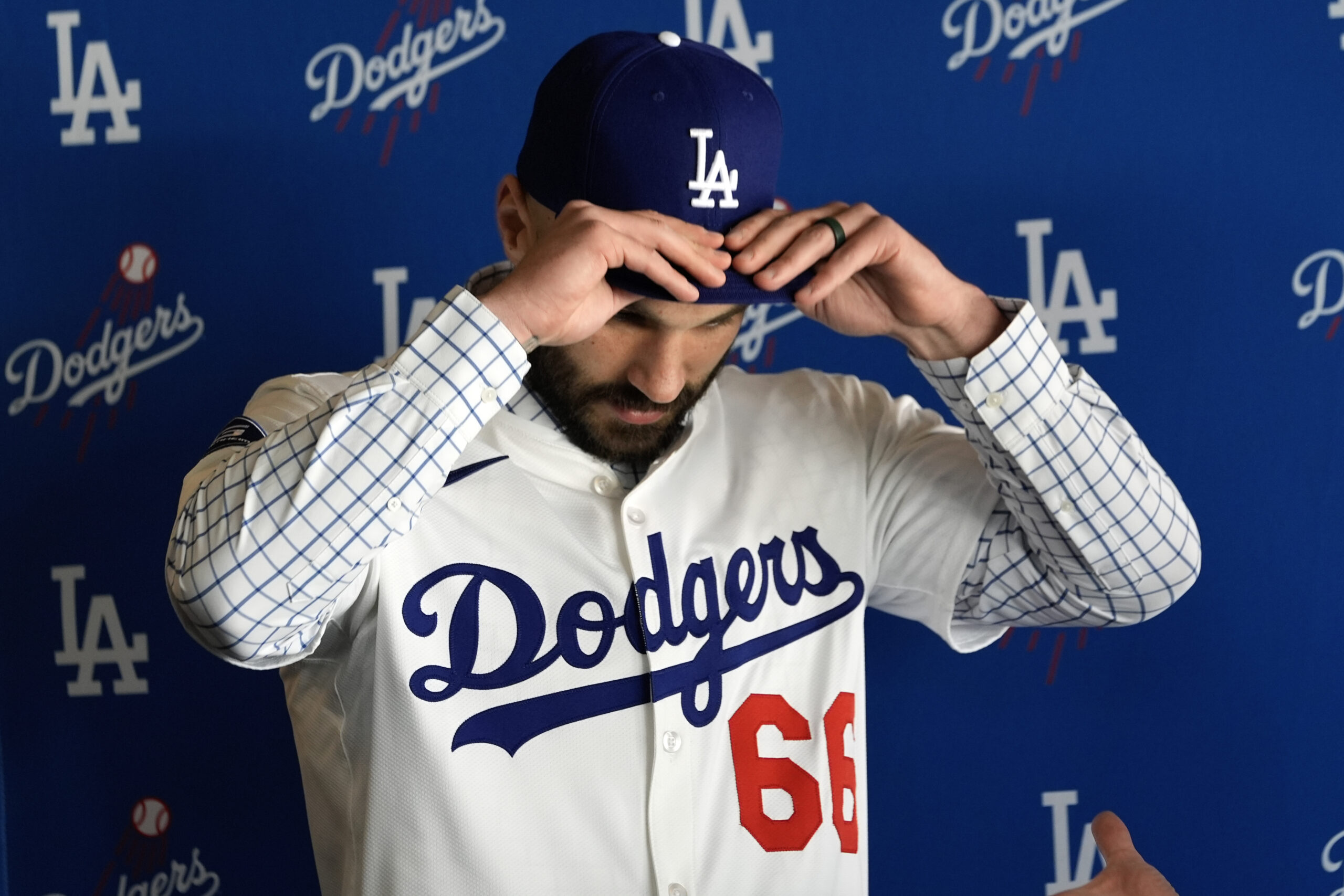 New Dodgers relief pitcher Tanner Scott dons his new cap...