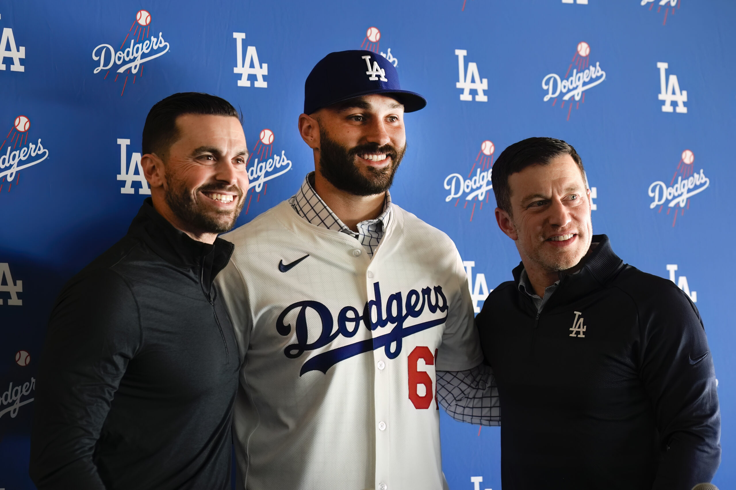 New Dodgers relief pitcher Tanner Scott, center, poses with Dodgers...