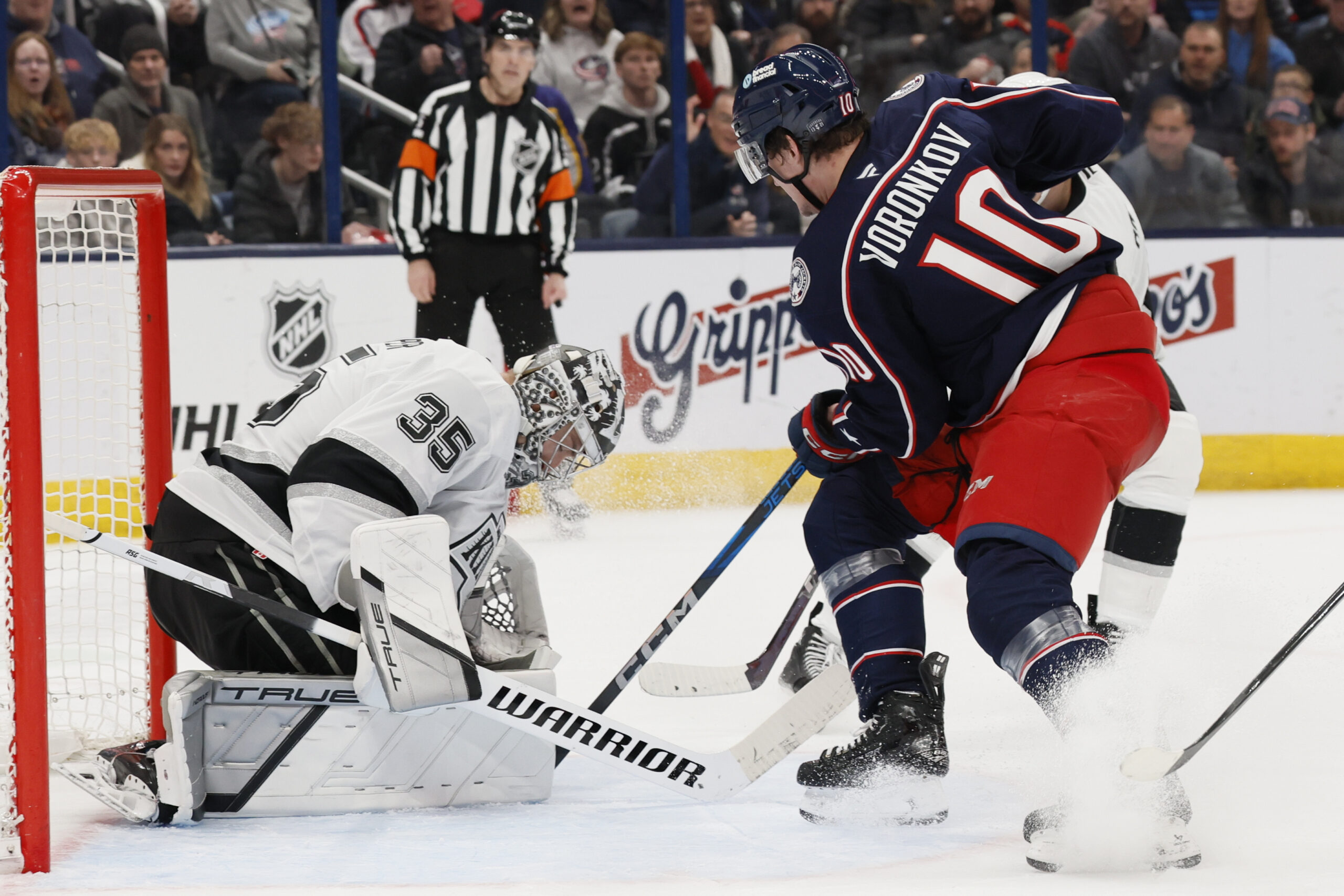 Kings’ Darcy Kuemper, left, makes a save against Columbus Blue...