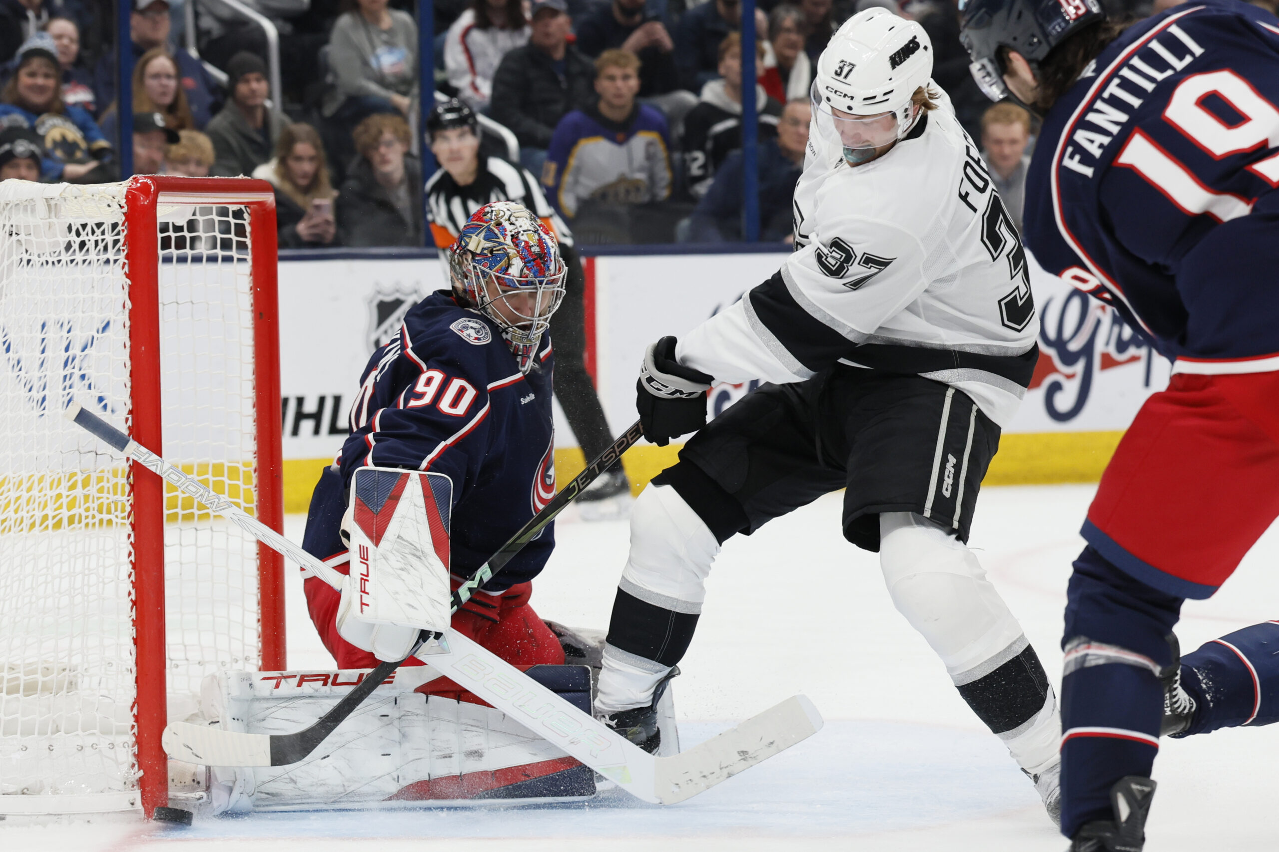 Columbus Blue Jackets’ Elvis Merzlikins, left, makes a save against...