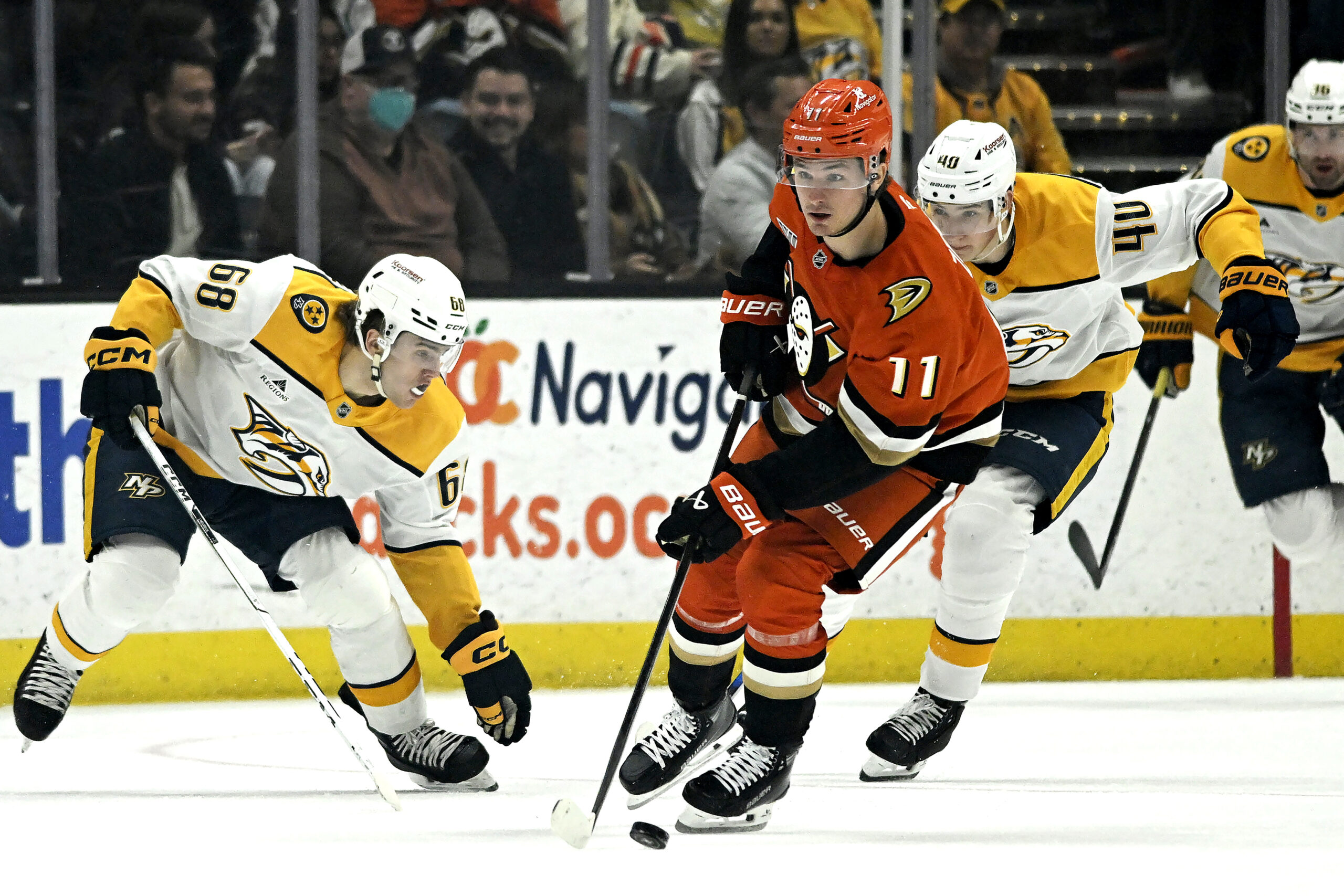 Ducks center Trevor Zegras (11) takes the puck past Nashville...