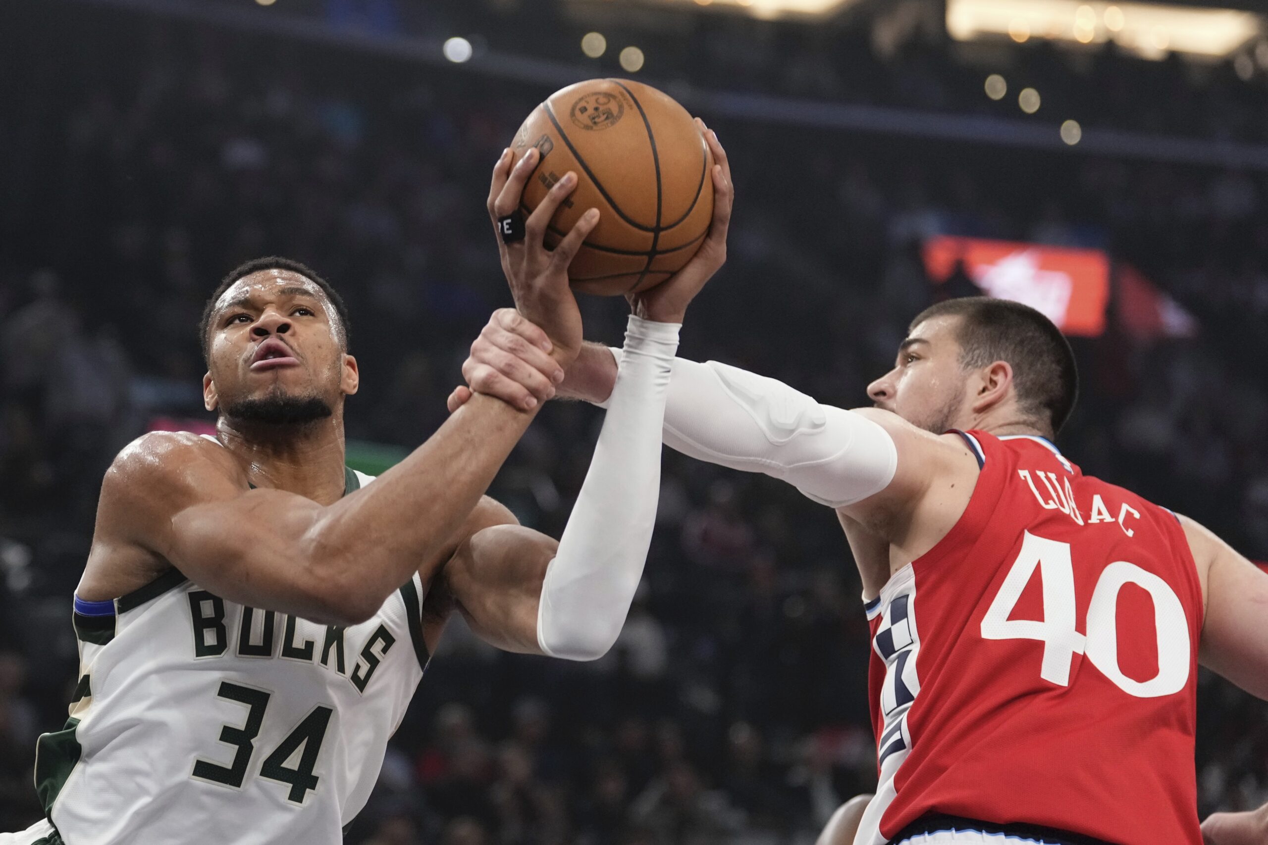 Milwaukee Bucks forward Giannis Antetokounmpo, left, is fouled by Clippers...