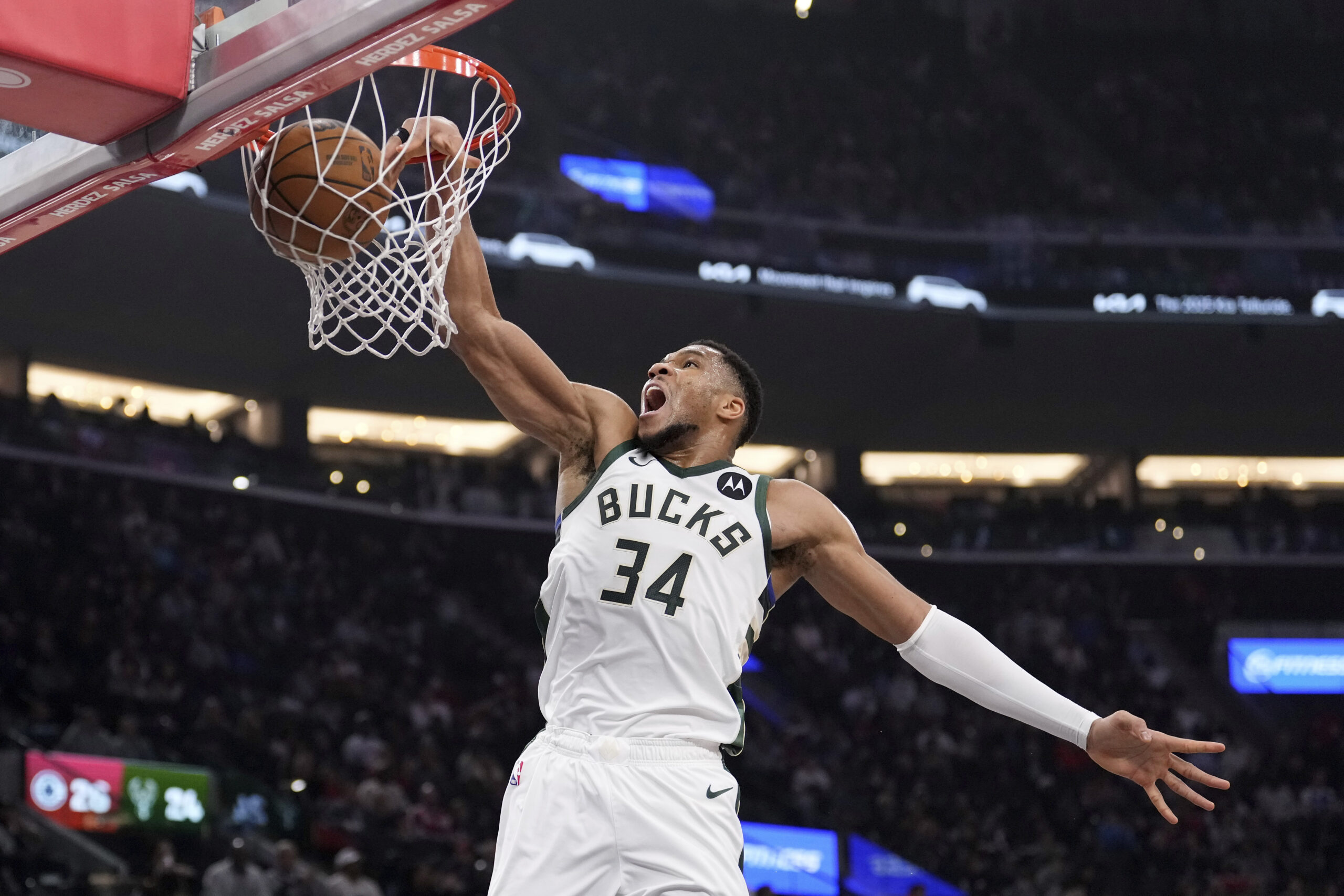 Milwaukee Bucks forward Giannis Antetokounmpo dunks during the first half...