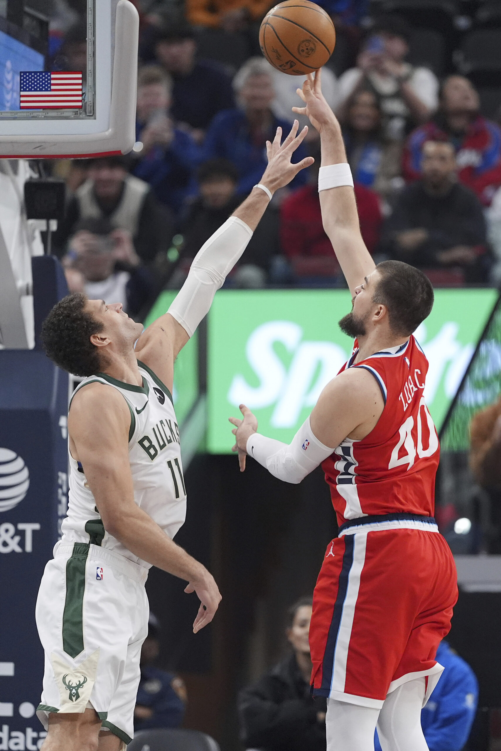 Clippers center Ivica Zubac, right, shoots as Milwaukee Bucks center...