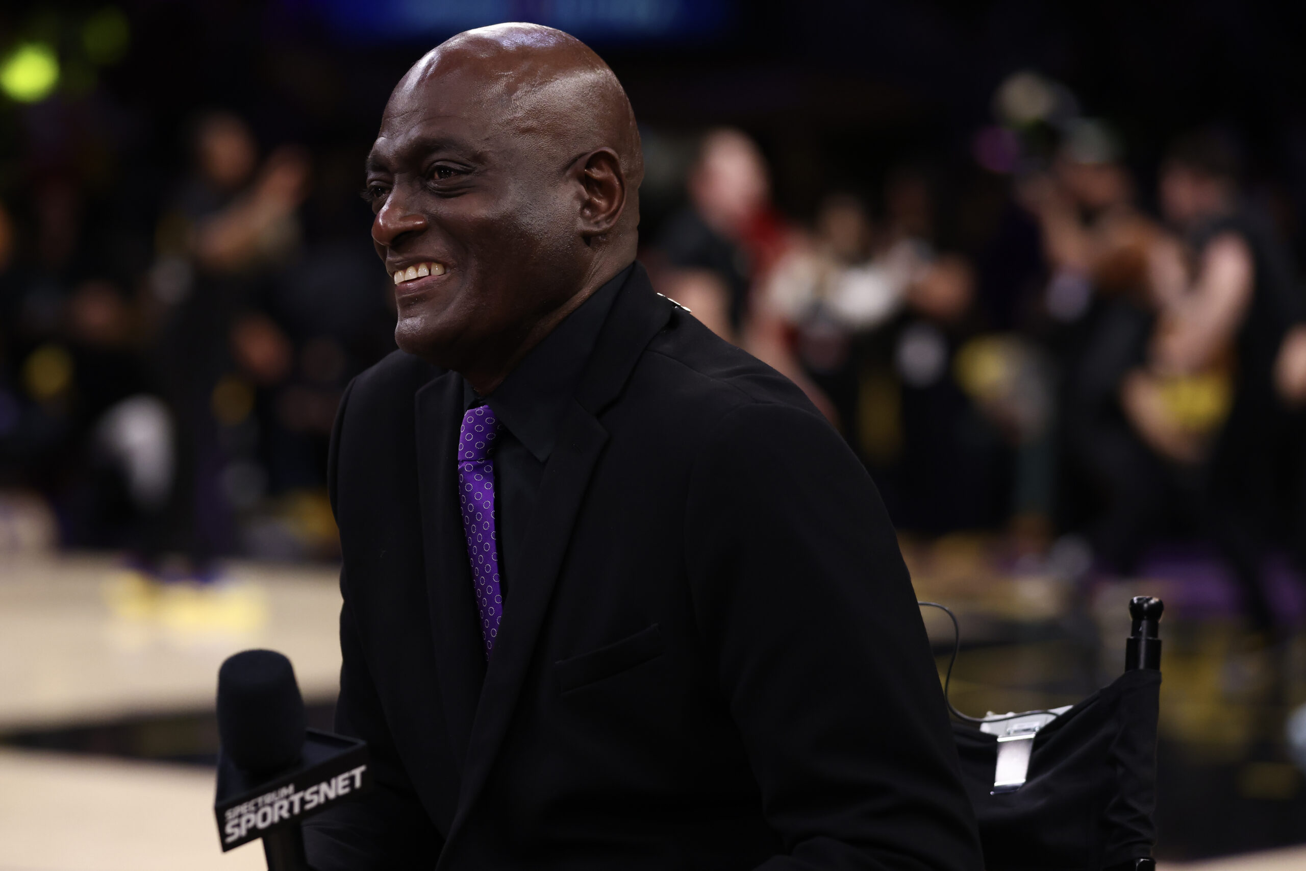 Former Lakers star Michael Cooper talks to reporters before a...