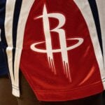 A detail of the Houston Rockets logo on the side of Houston Rockets jersey shorts