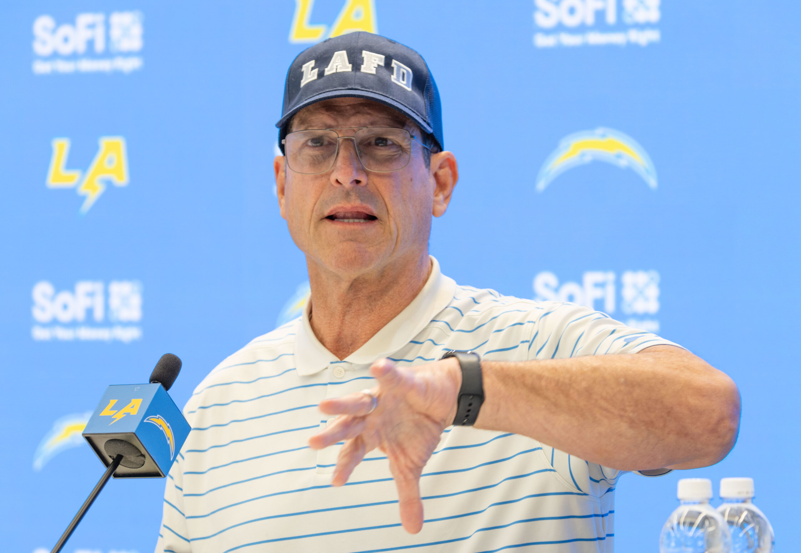 Chargers head coach Jim Harbaugh speaks to reporters during a...