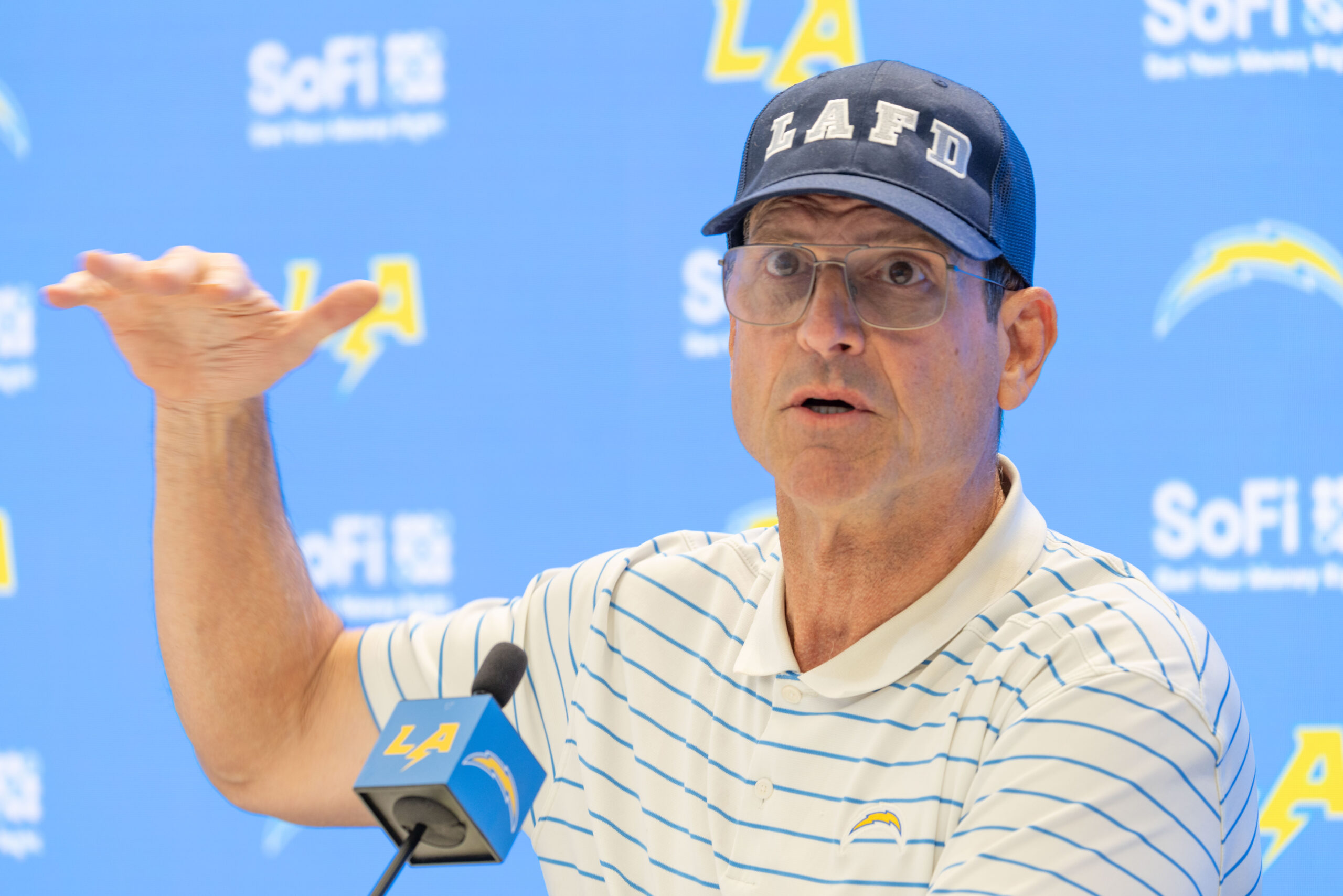 Chargers head coach Jim Harbaugh speaks to reporters during a...