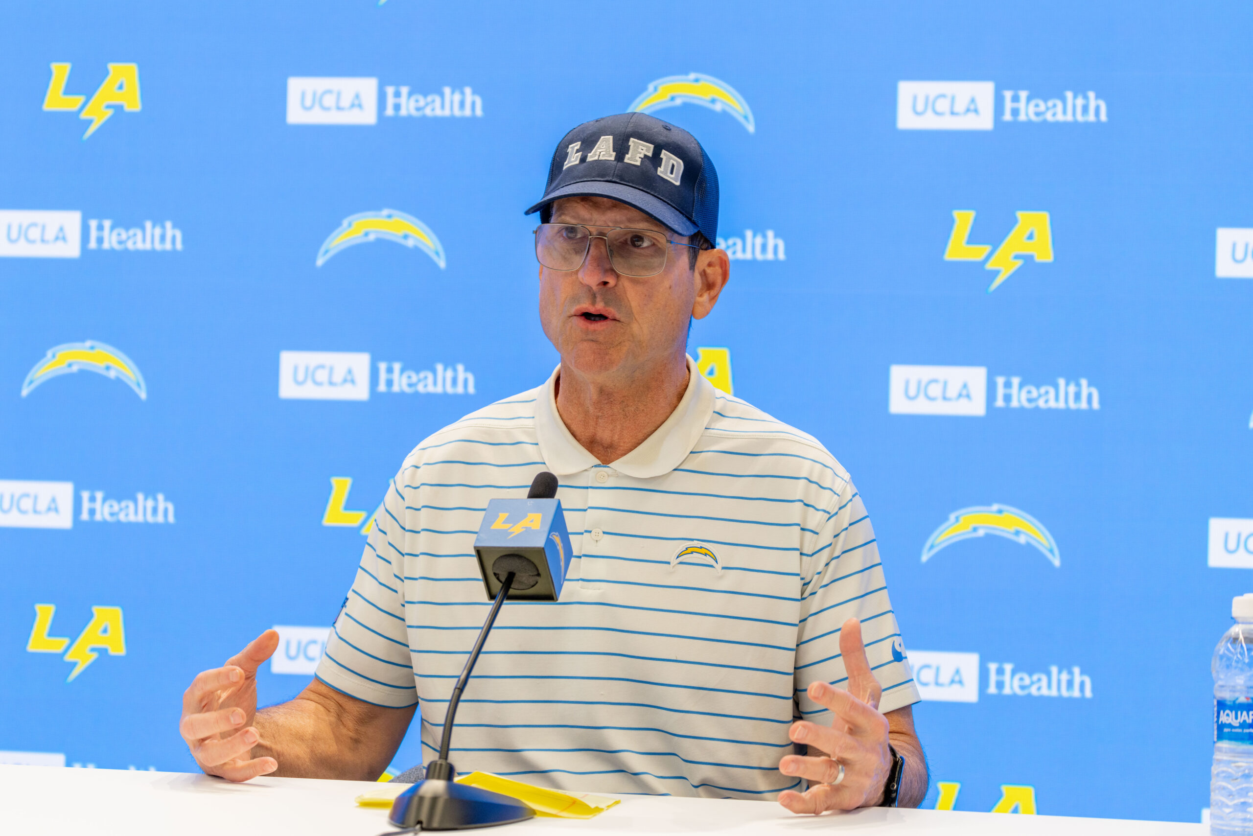 Chargers head coach Jim Harbaugh speaks to reporters during a...