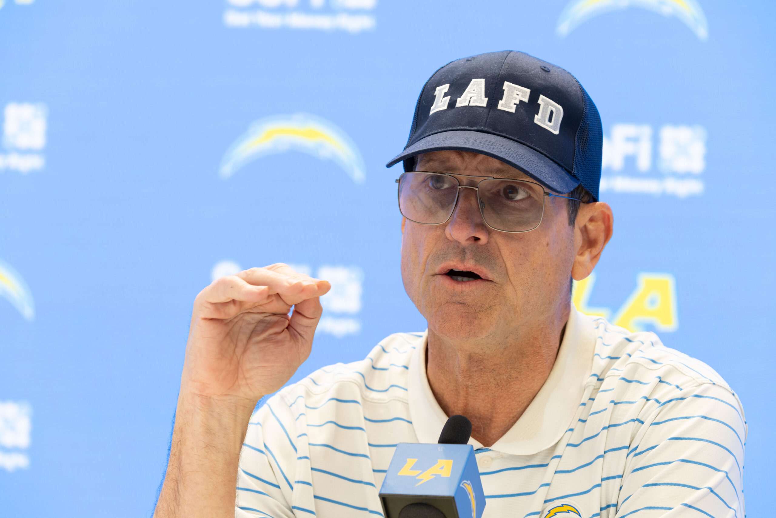 Chargers head coach Jim Harbaugh speaks to reporters during a...