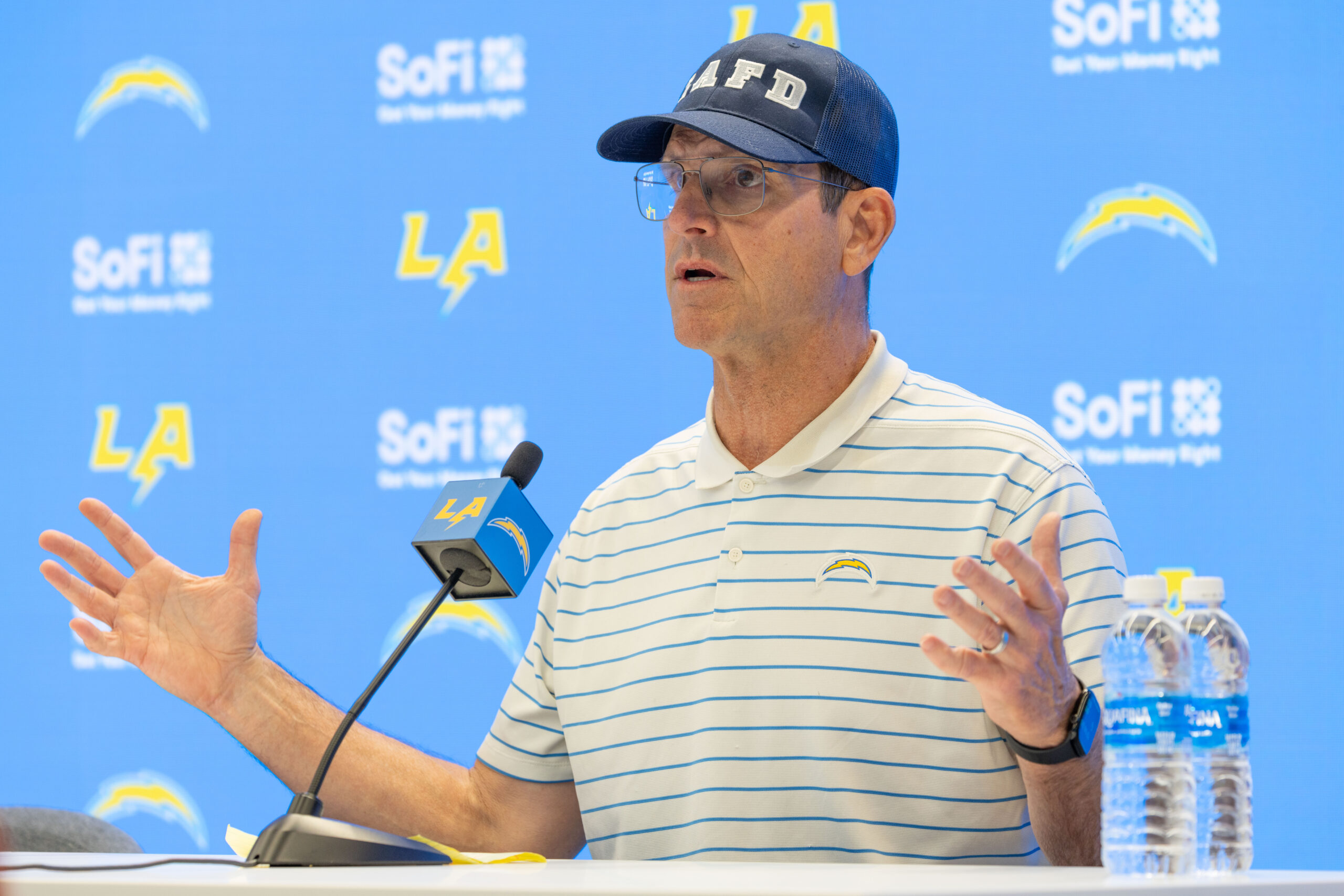 Chargers head coach Jim Harbaugh speaks to reporters during a...