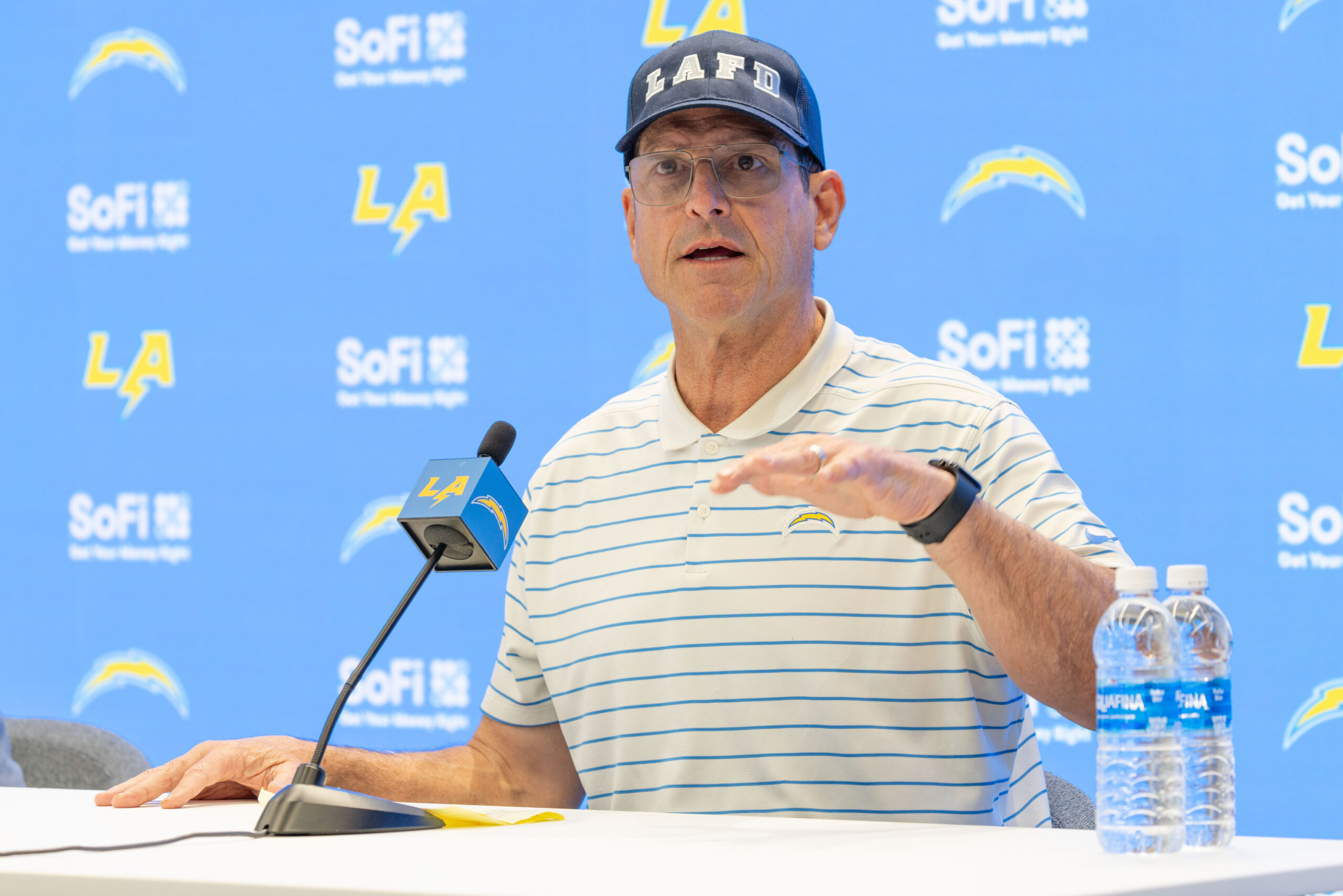 Chargers head coach Jim Harbaugh speaks to reporters during a...