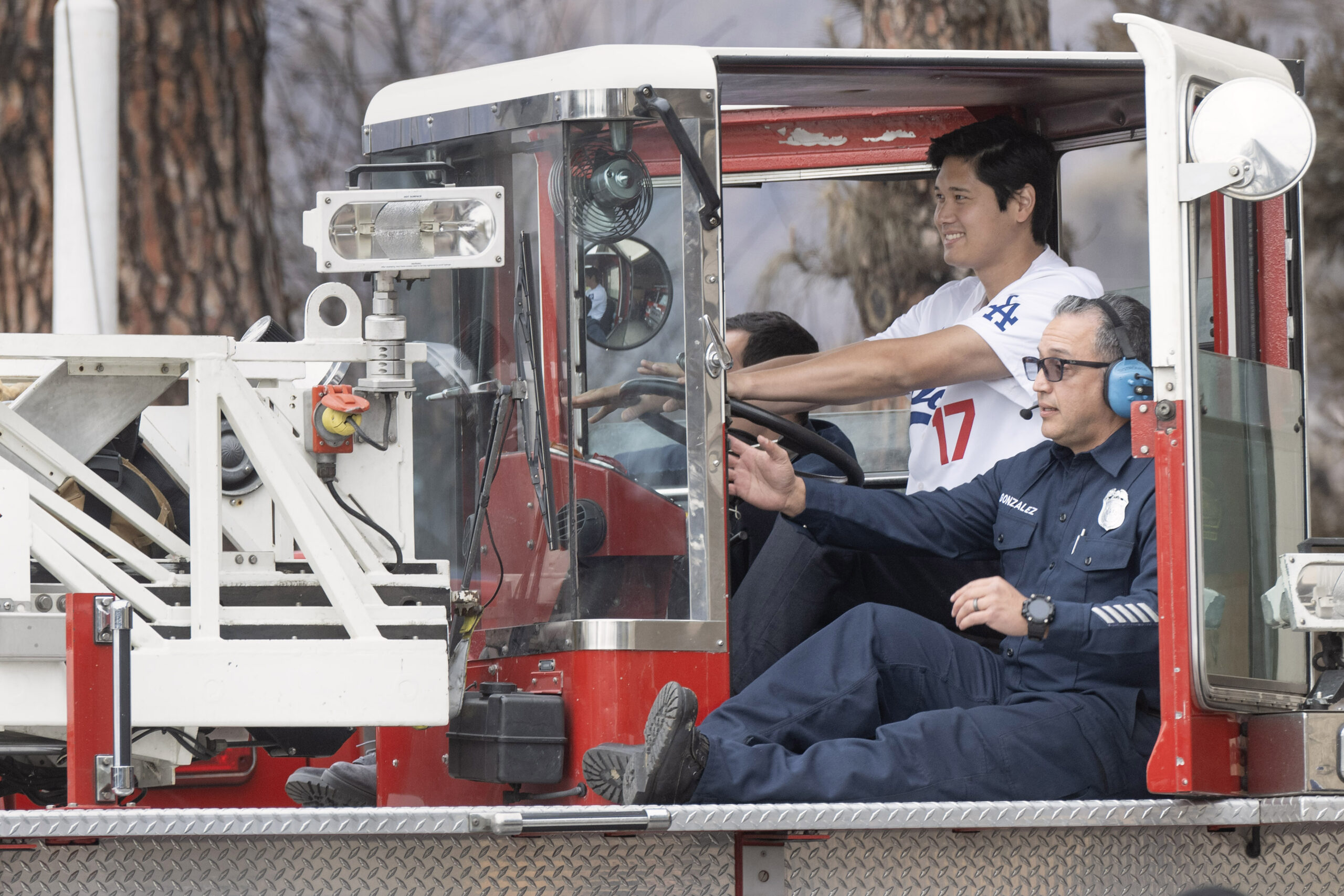 From right, Firefighter Paramedic Alfred Gonzalez helps Dodgers star Shohei...