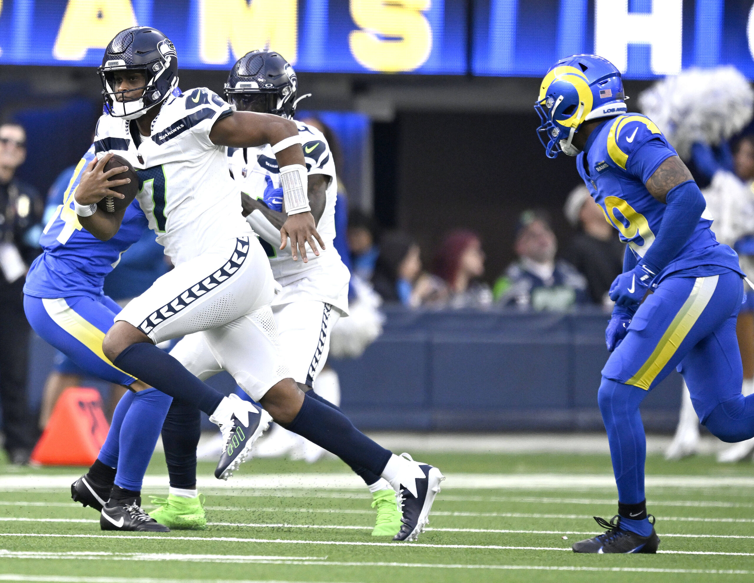 Seattle quarterback Geno Smith heads up field during the first...