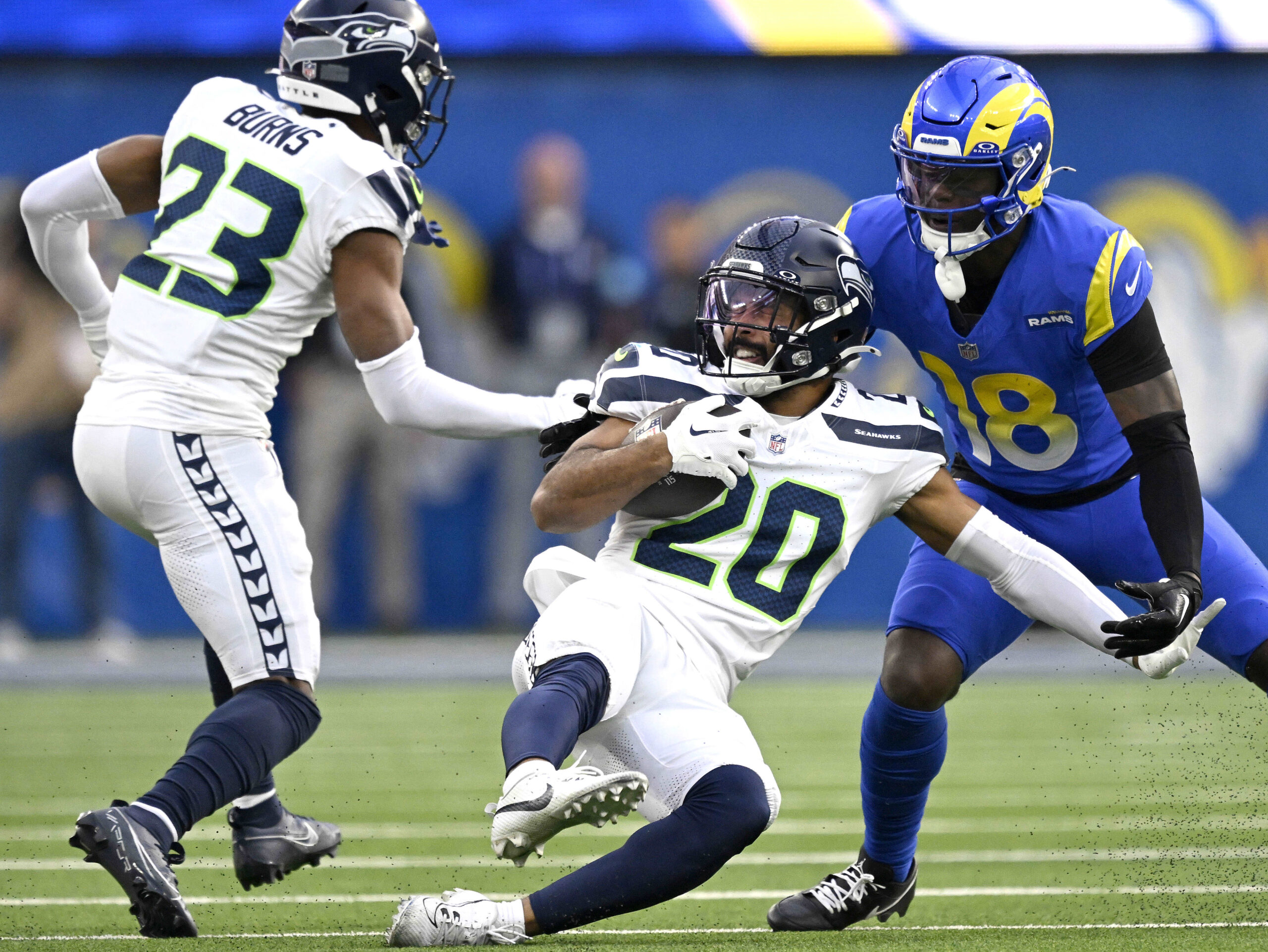 Seattle’s Julian Love slides to the ground after intercepting a...