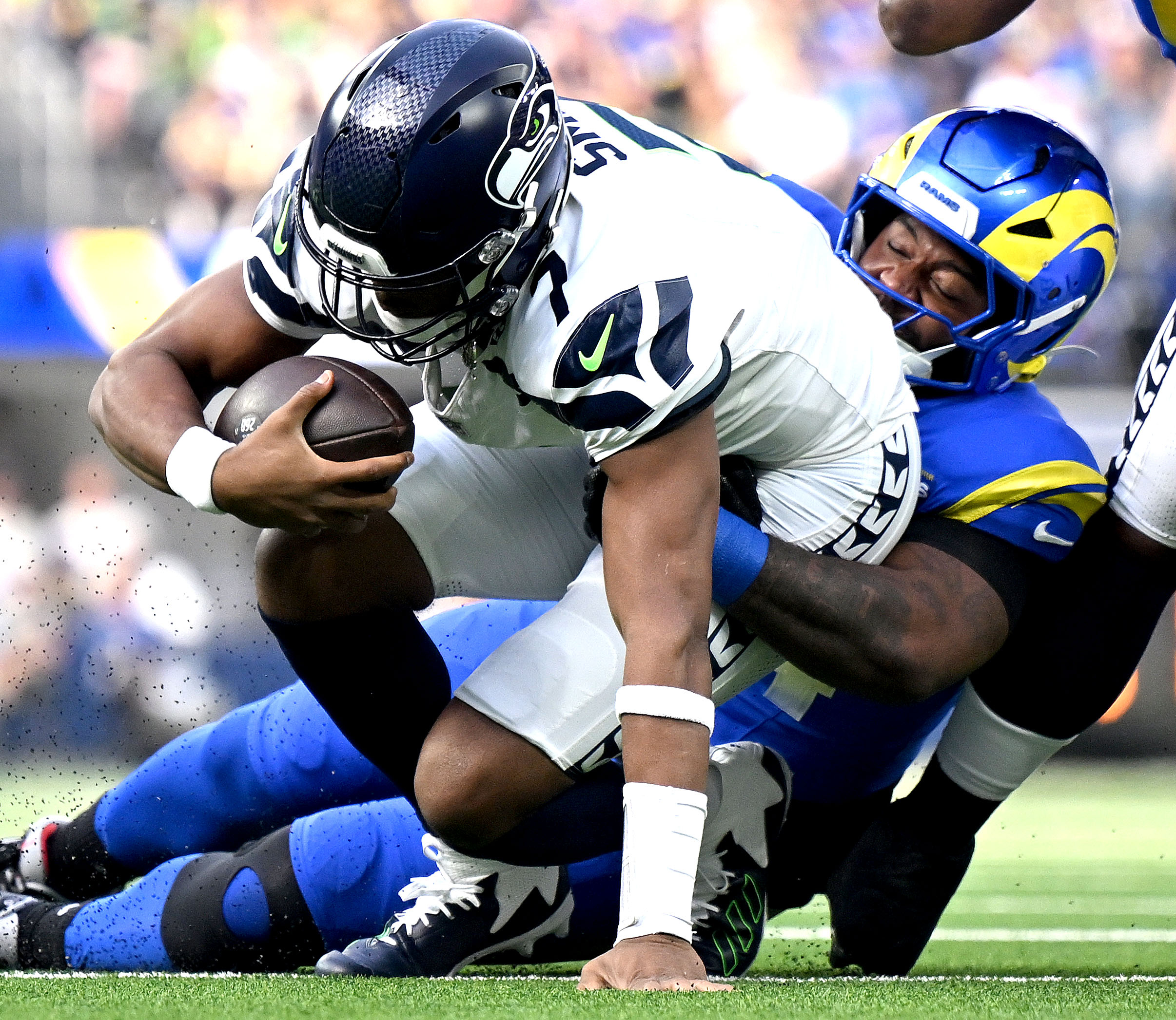 Rams defensive end Desjuan Johnson sacks Seattle quarterback Geno Smith...