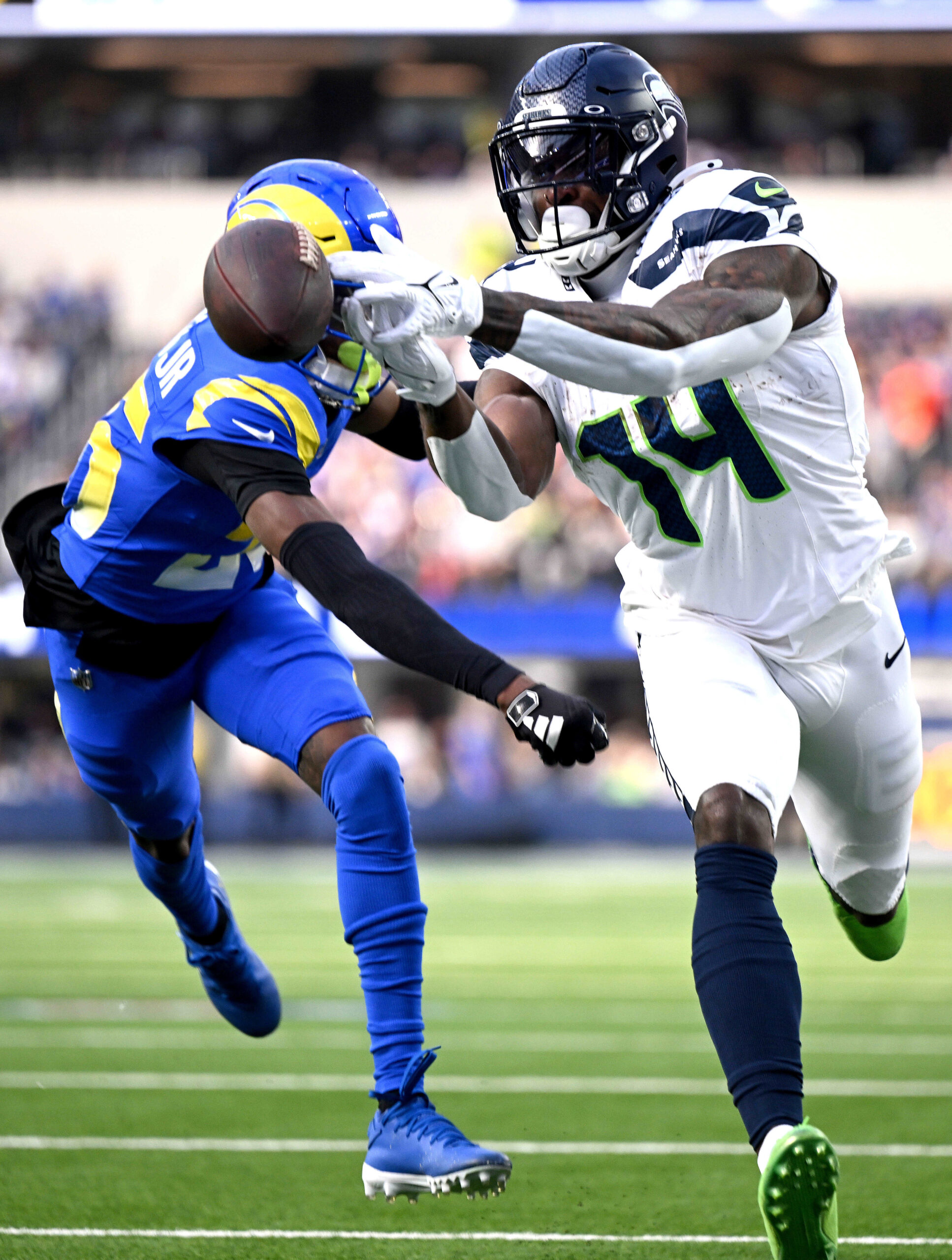 Seattle receiver D.K. Metcalf has a ball bounce off his...