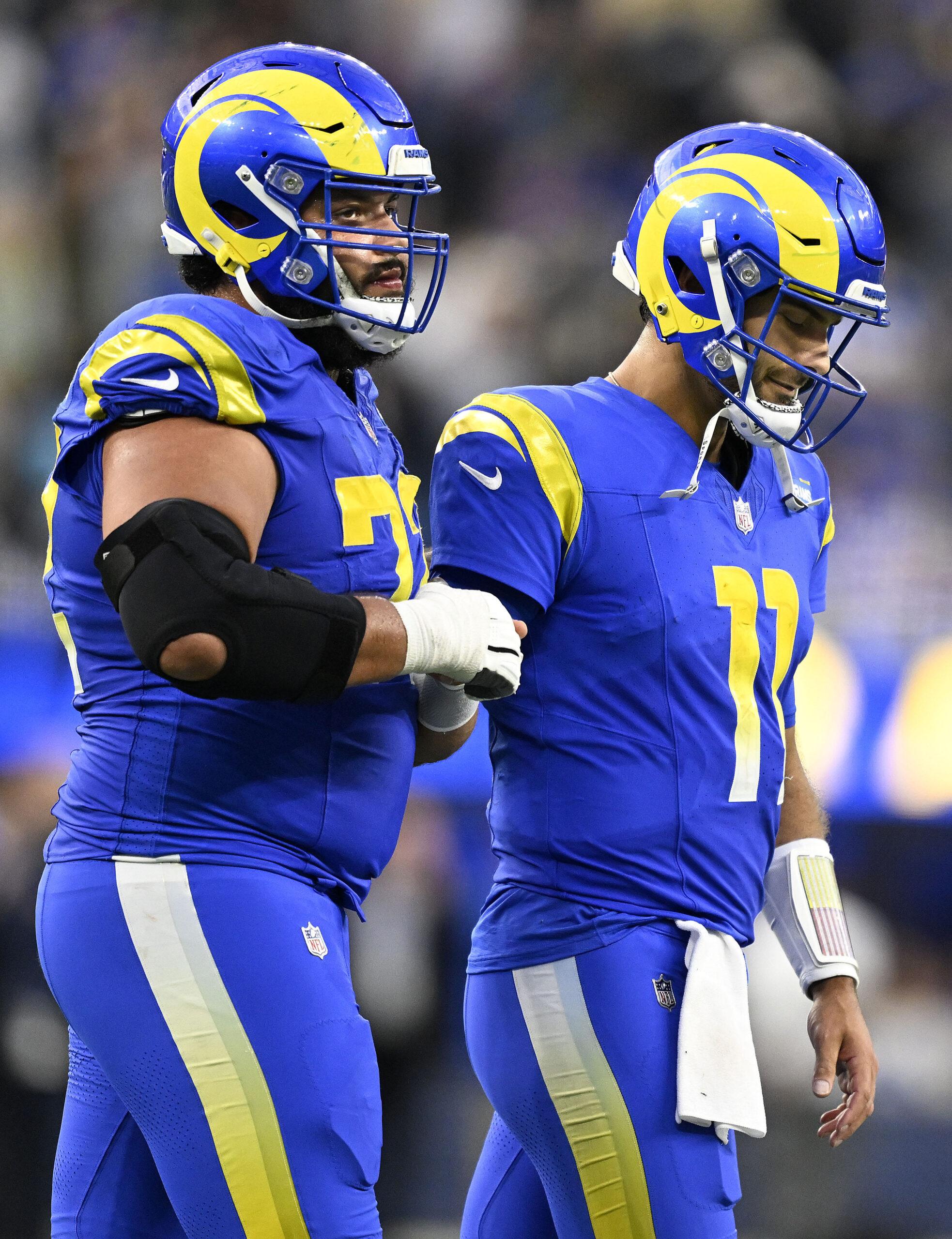 Rams quarterback Jimmy Garoppolo, right, walks off the field with...