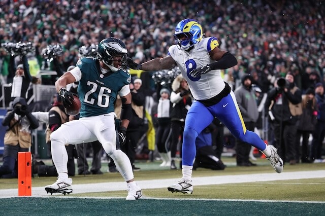 Jan 19, 2025; Philadelphia, Pennsylvania, USA; Philadelphia Eagles running back Saquon Barkley (26) scores a touchdown past Los Angeles Rams linebacker Jared Verse (8) in the first half in a 2025 NFC divisional round game at Lincoln Financial Field. Mandatory Credit: Bill Streicher-Imagn Images Jared Verse, Rams, Eagles