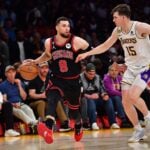 Chicago Bulls guard Zach LaVine dribbles down the court while defended by Los Angeles Lakers guard Austin Reaves