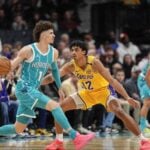 Charlotte Hornets point guard LaMelo Ball looks to make a pass against Los Angeles Lakers defense