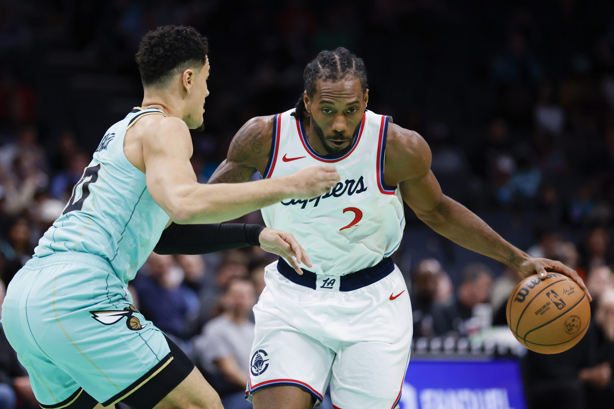 Clippers forward Kawhi Leonard drives as Charlotte Hornets guard Josh...