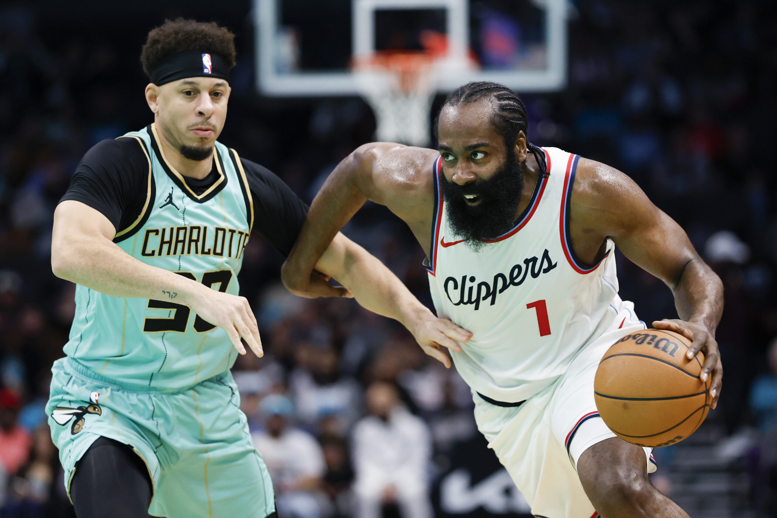 Clippers guard James Harden (1) drives past Charlotte Hornets guard...