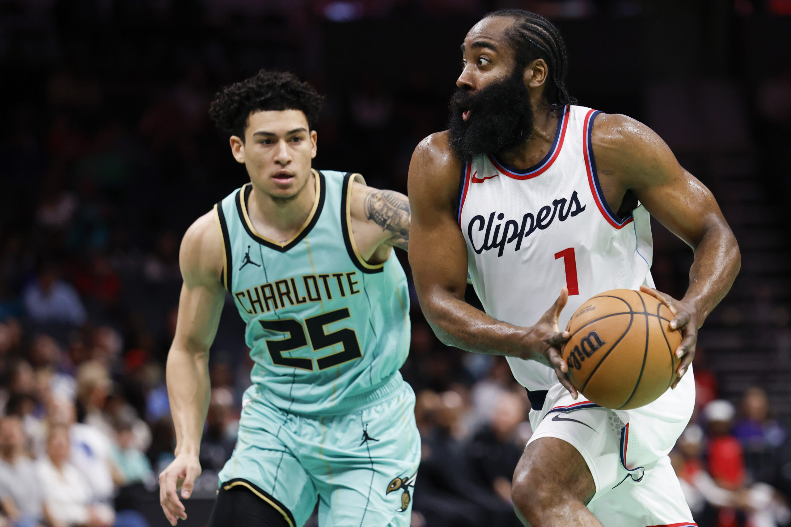 Clippers guard James Harden (1) drives to the basket past...