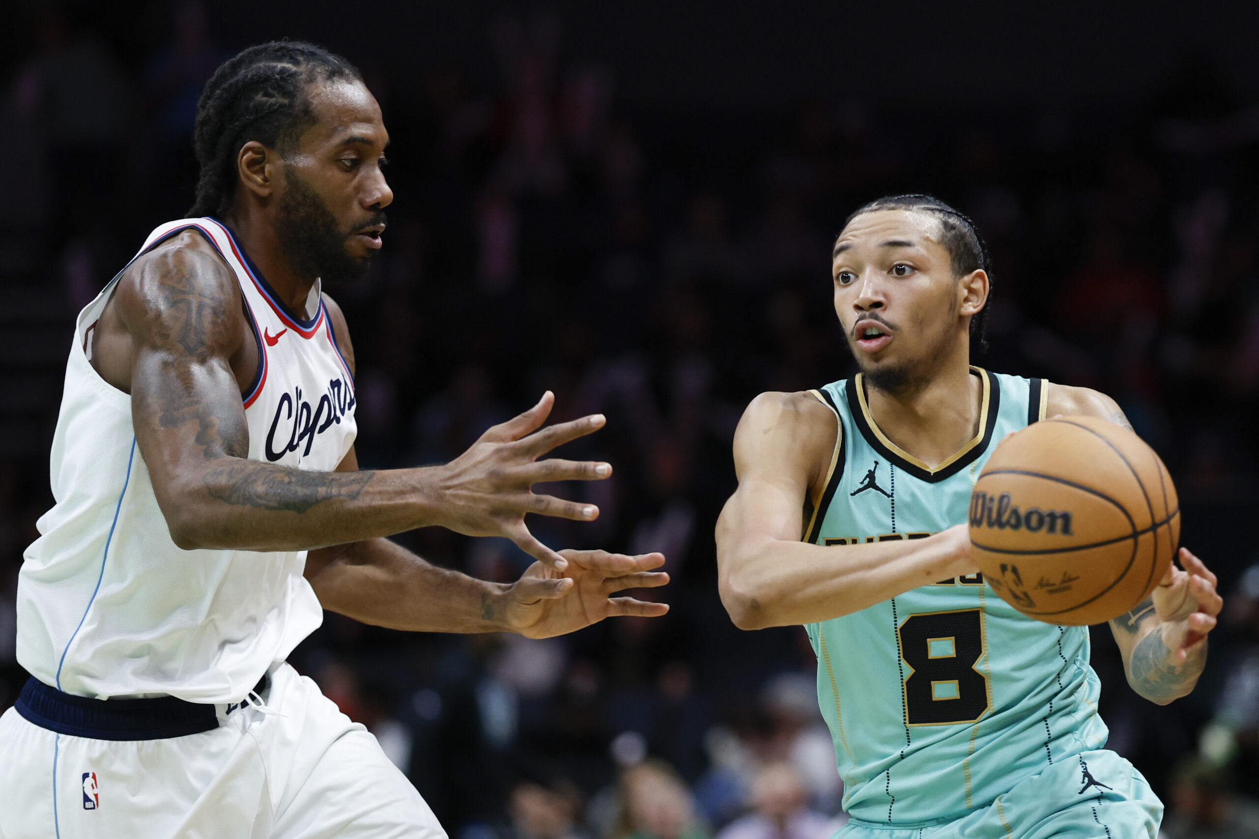 Charlotte Hornets guard Nick Smith Jr. (8) passes the ball...