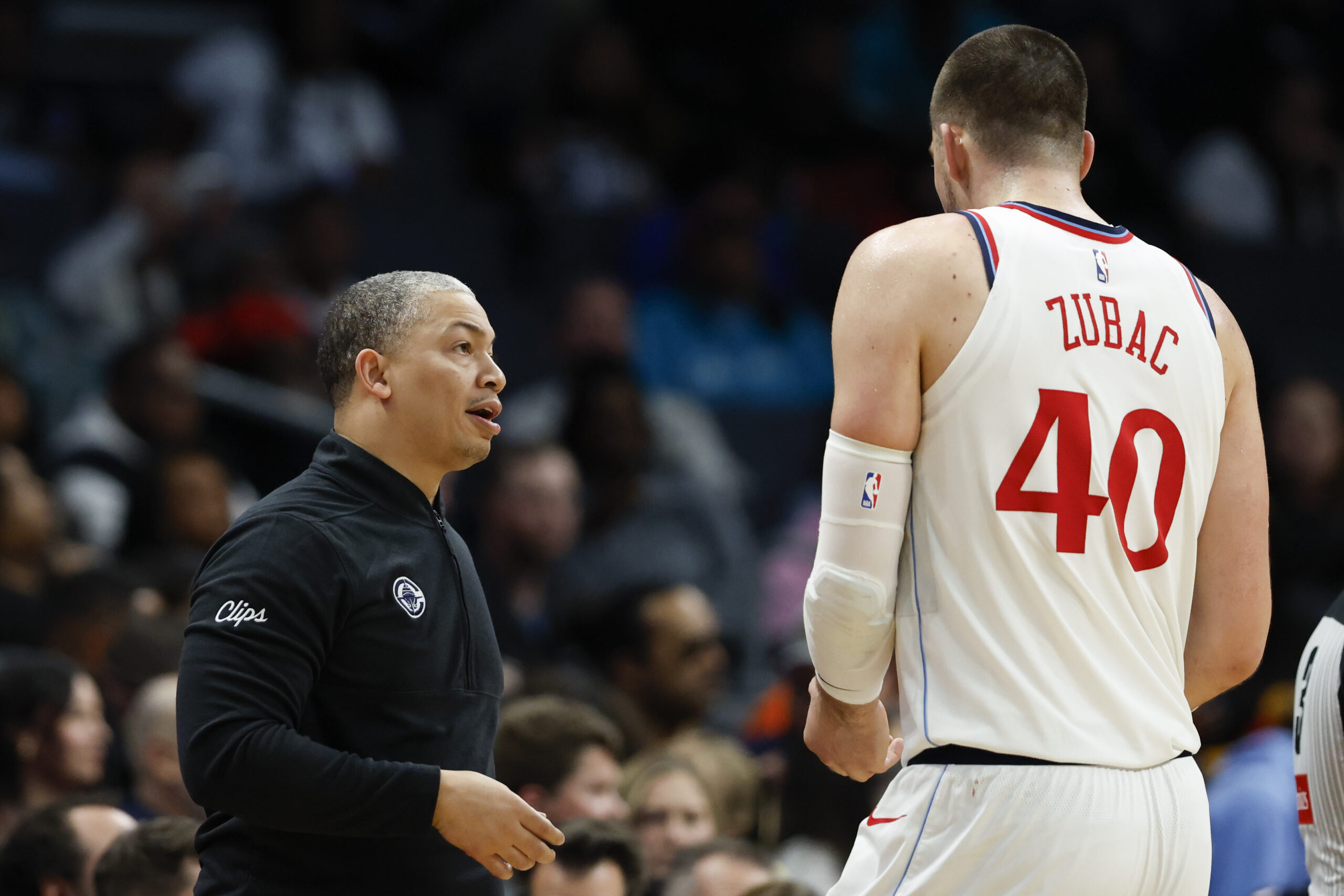 Clippers head coach Tyronn Lue, left, talks to center Ivica...