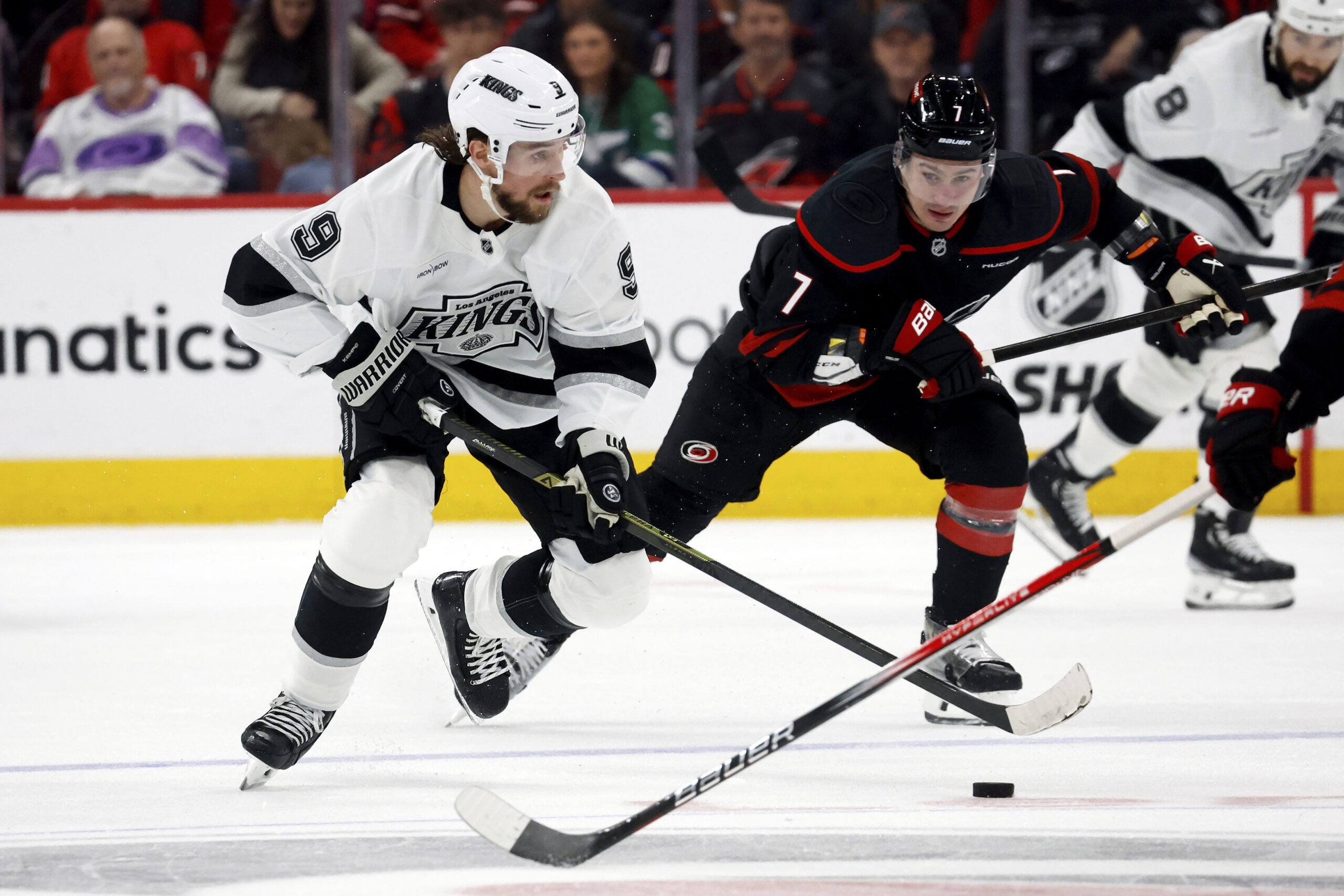 Kings’ Adrian Kempe (9) controls the puck after taking it...