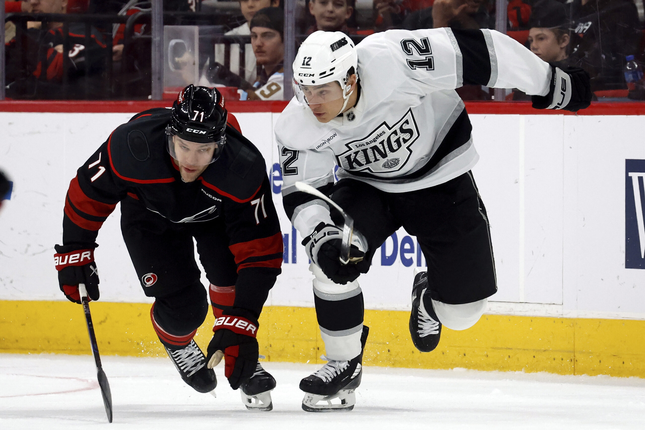 Carolina Hurricanes’ Taylor Hall (71) and Kings’ Trevor Moore (12)...