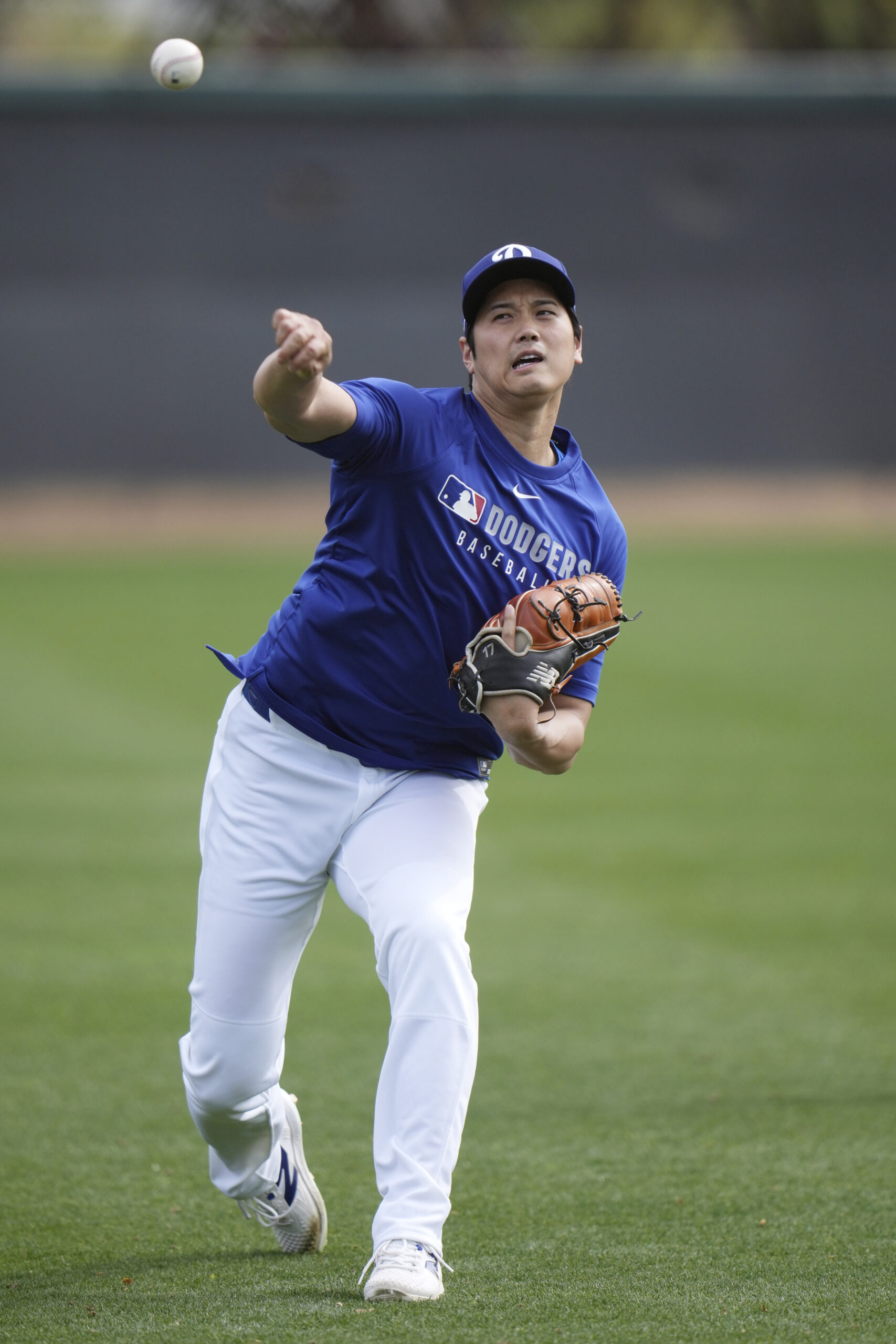 Dodgers star Shohei Ohtani warms up on Tuesday at their...