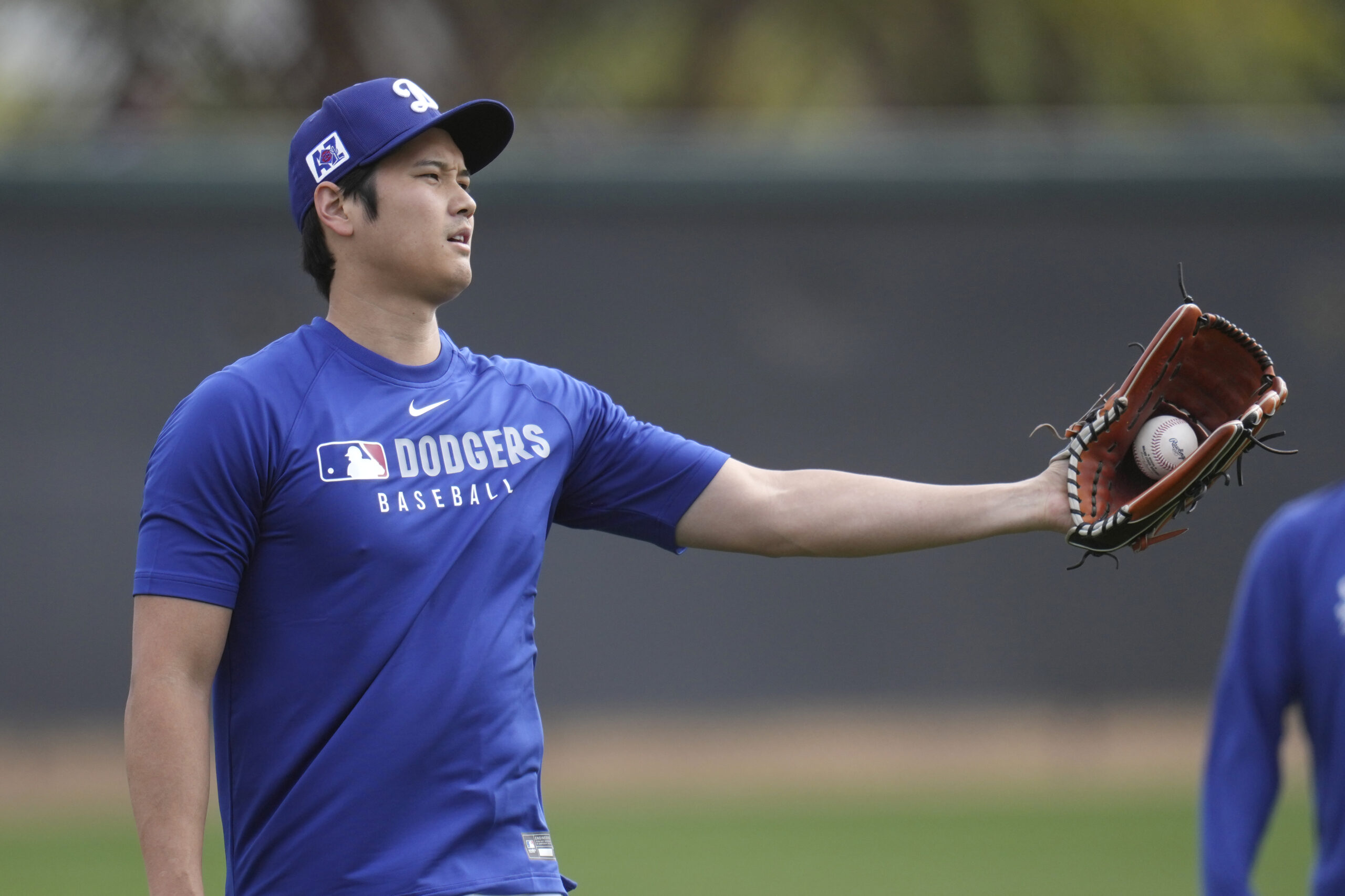 Dodgers star Shohei Ohtani warms up on Tuesday at their...