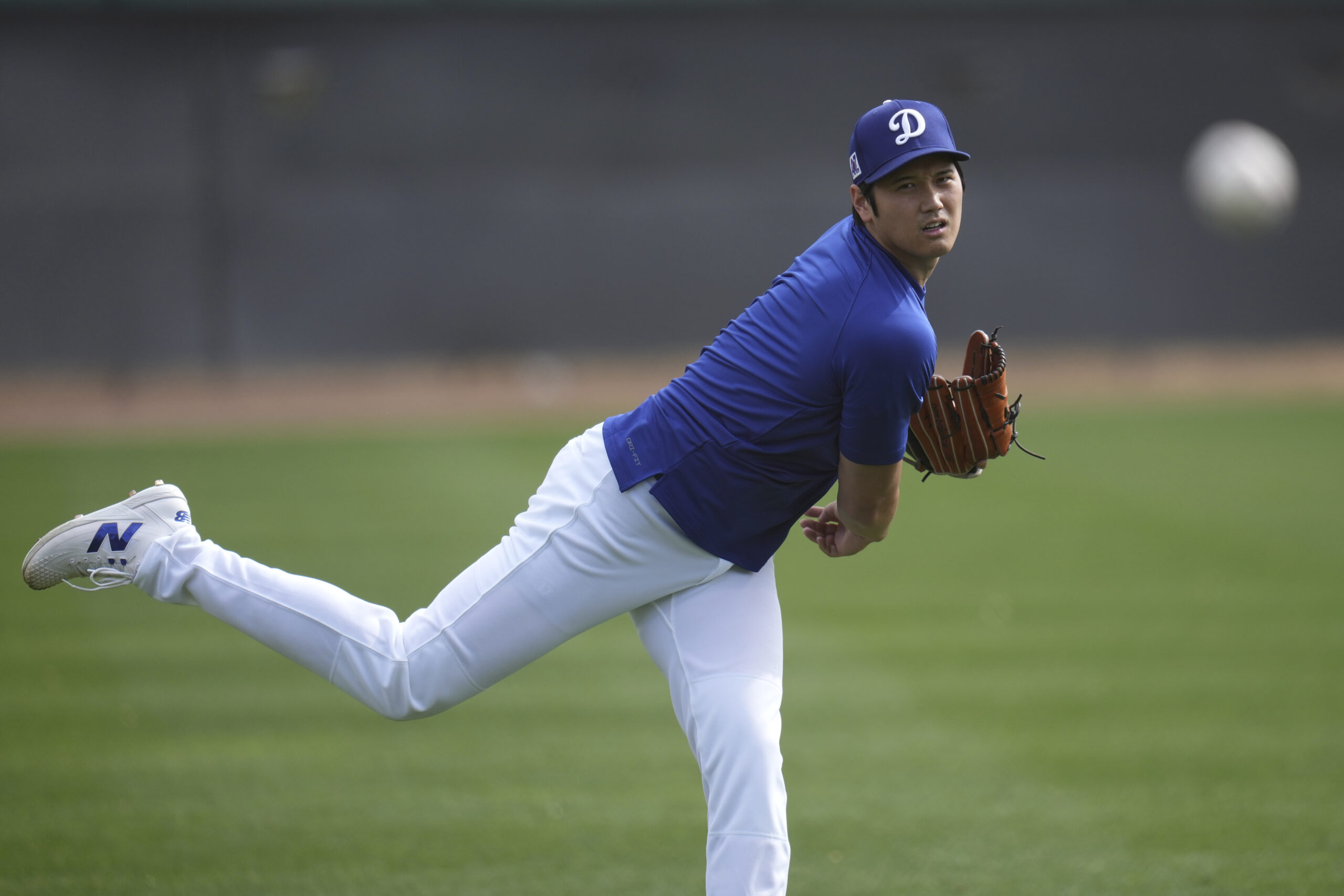 Dodgers star Shohei Ohtani warms up on Tuesday at their...