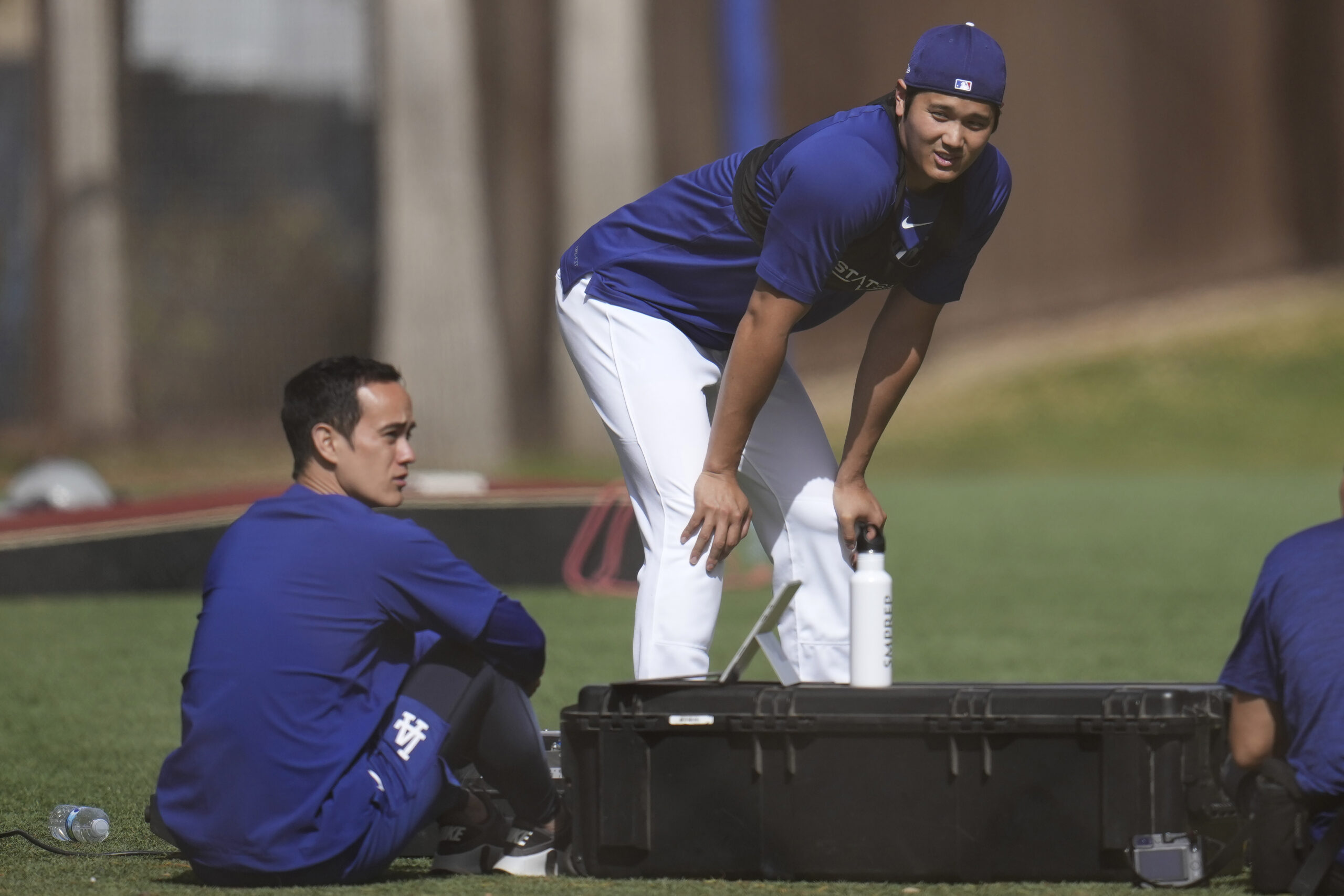 Dodgers star Shohei Ohtani, right, talks with Will Ireton, left,...