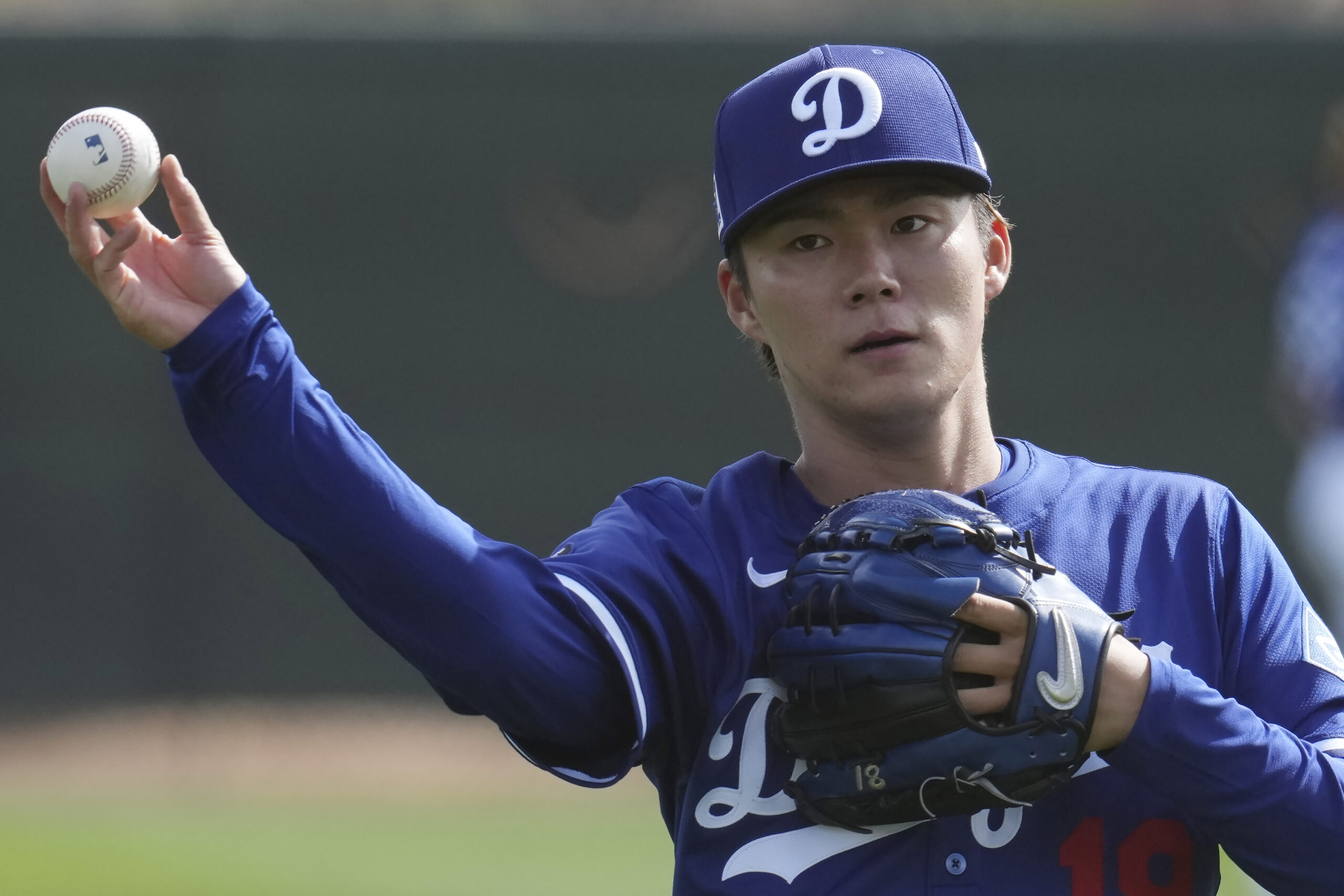 Dodgers pitcher Yoshinobu Yamamoto warms up on Tuesday at their...