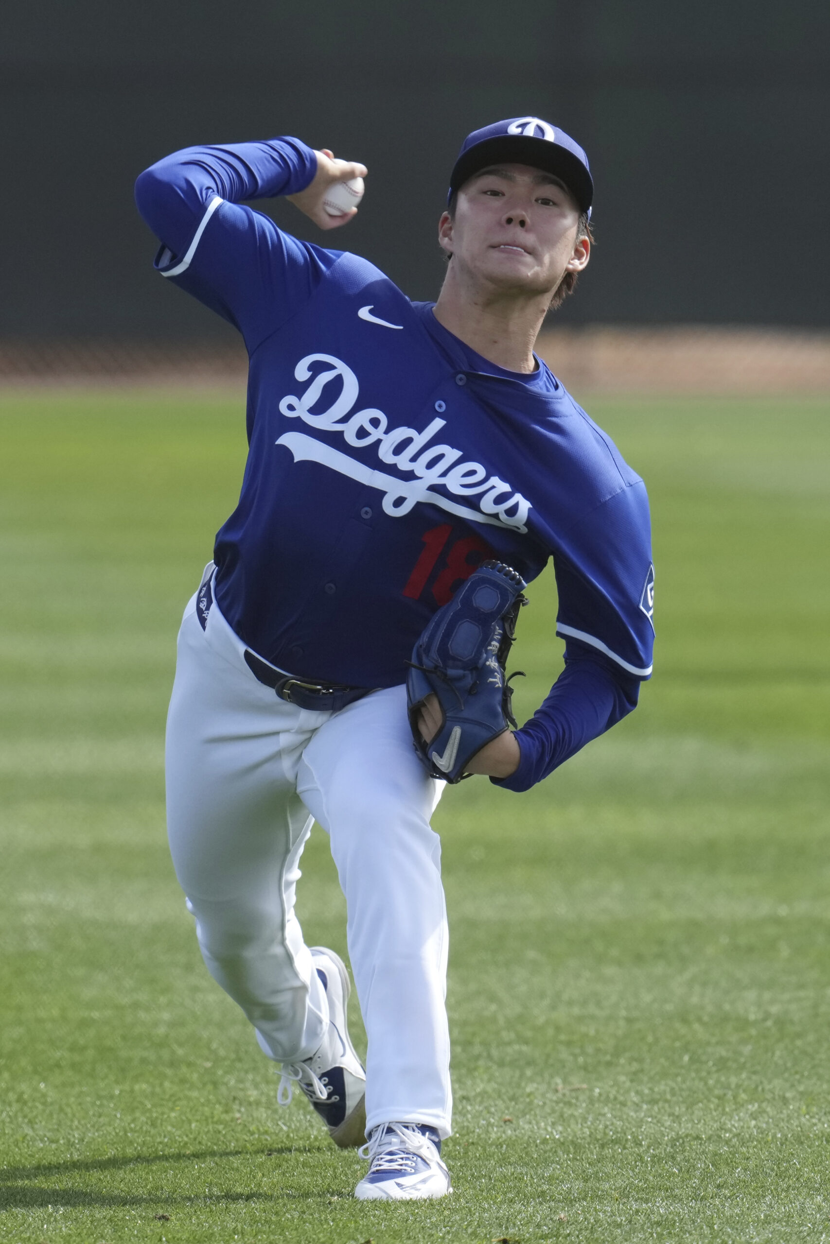 Dodgers pitcher Yoshinobu Yamamoto warms up on Tuesday at their...