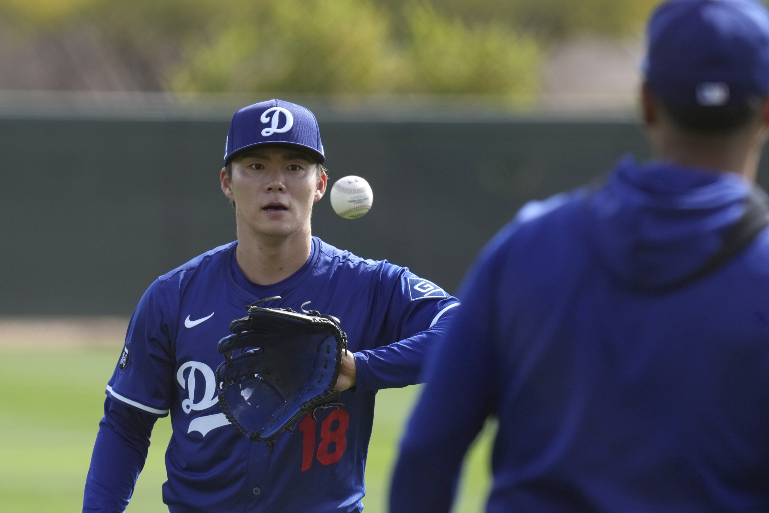 Dodgers pitcher Yoshinobu Yamamoto warms up on Tuesday at their...