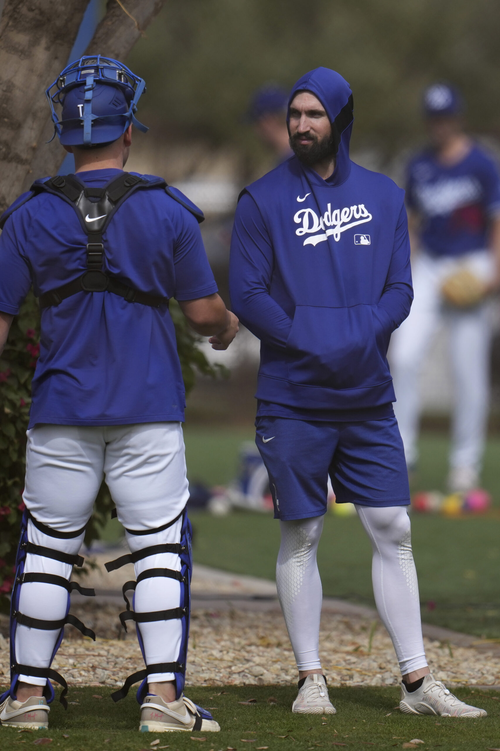 Dodgers pitcher Tony Gonsolin, right, talks with a catcher on...