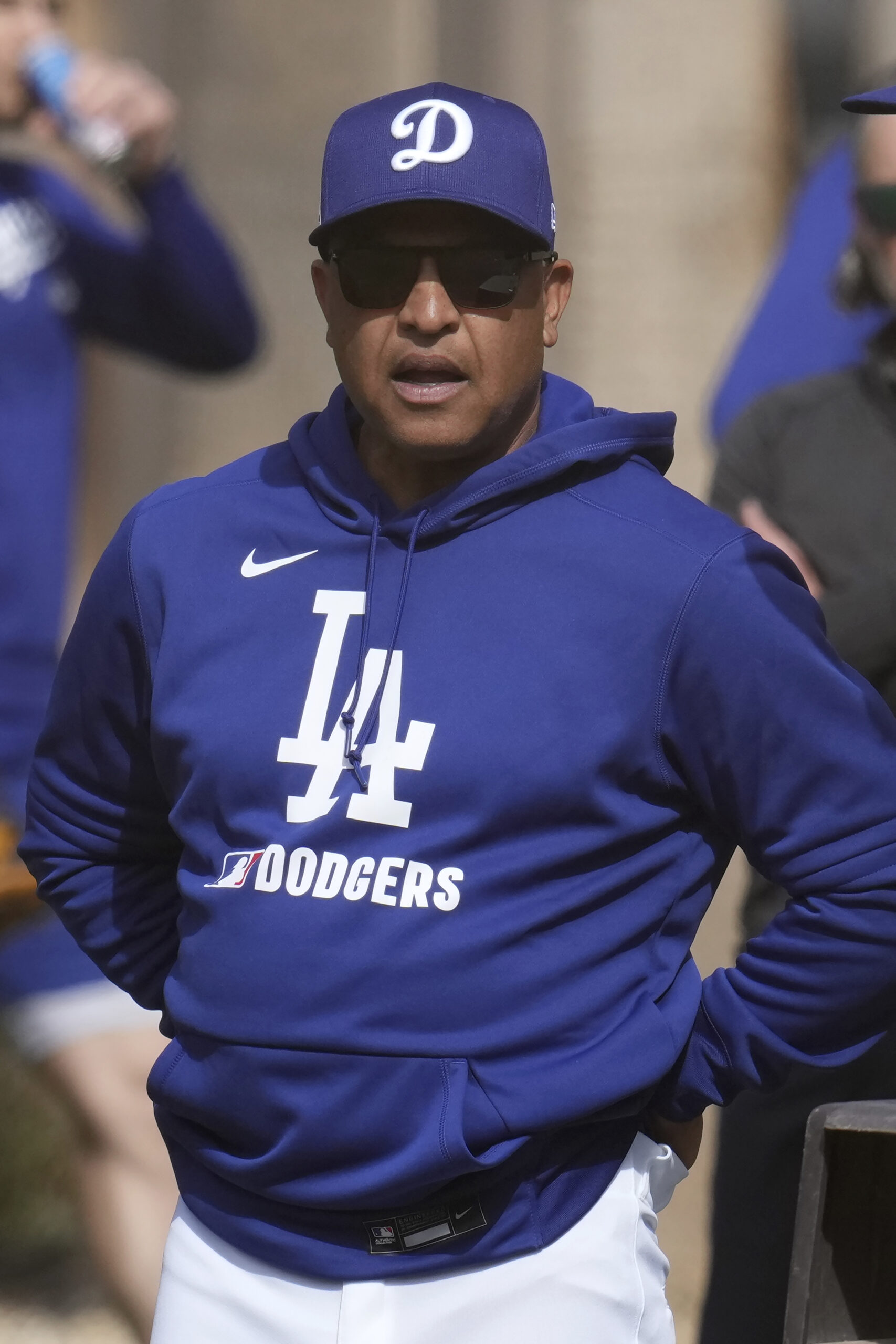 Dodgers manager Dave Roberts watches pitchers during throwing sessions on...