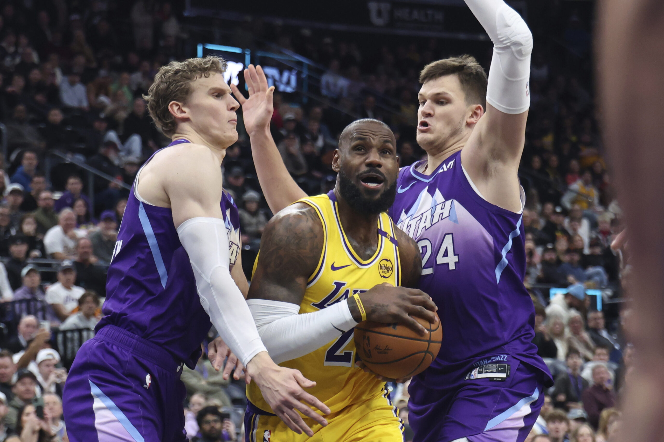 Lakers forward LeBron James drives between Utah Jazz forward Lauri...