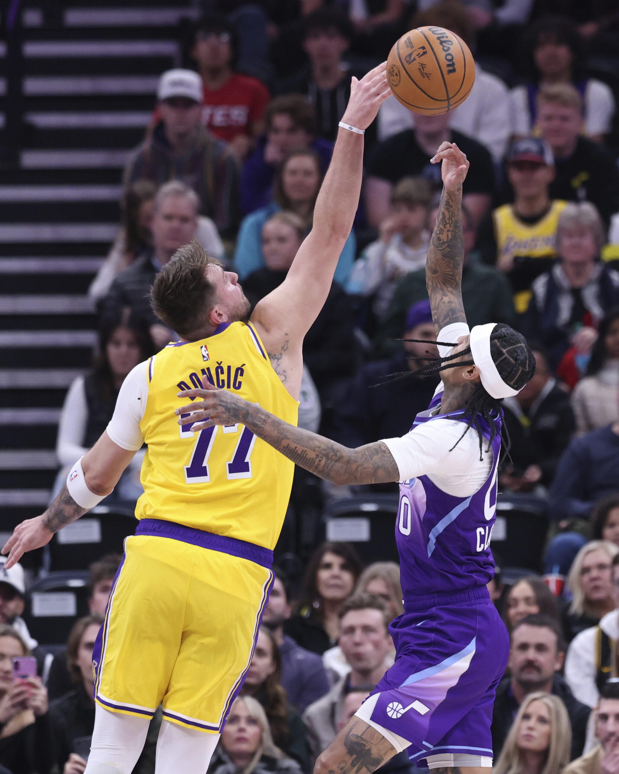 Lakers guard Luka Doncic (77) blocks the shot of Utah...